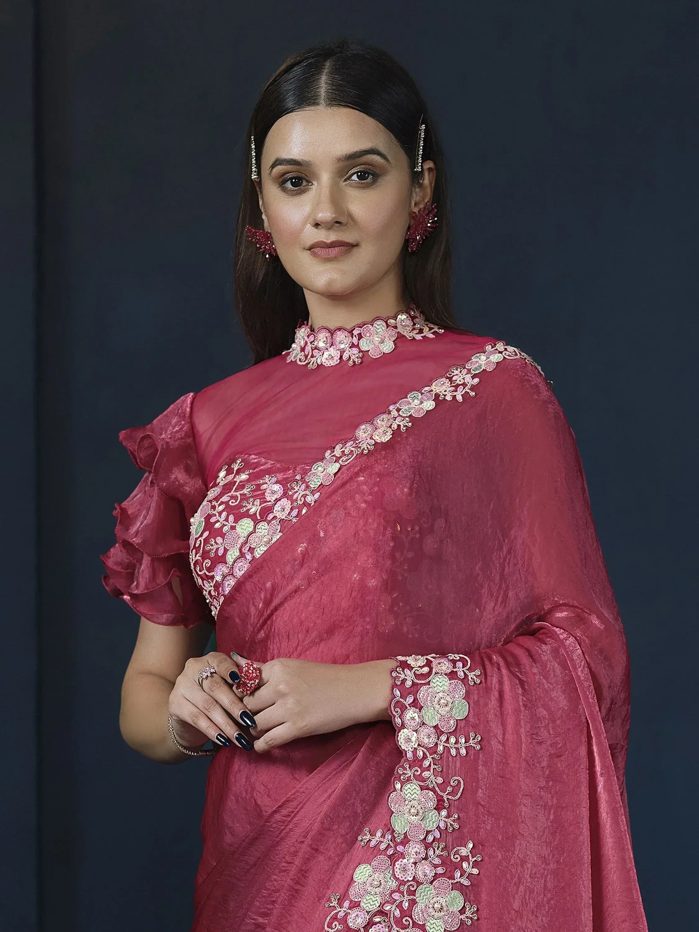 Pink embroidered saree with floral sequin work, ruffled sleeves, and matching jewelry for ethnic wear