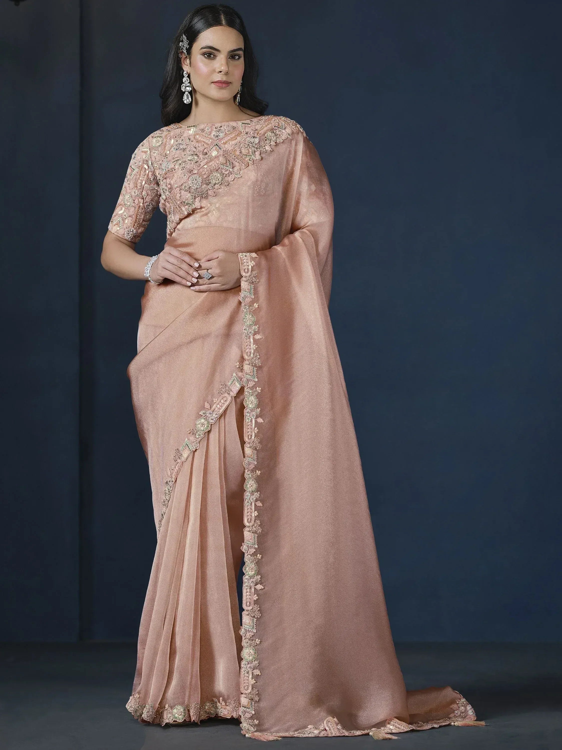 Elegant peach saree with intricate floral embroidery and sequin work, perfect for Indian ethnic occasions.