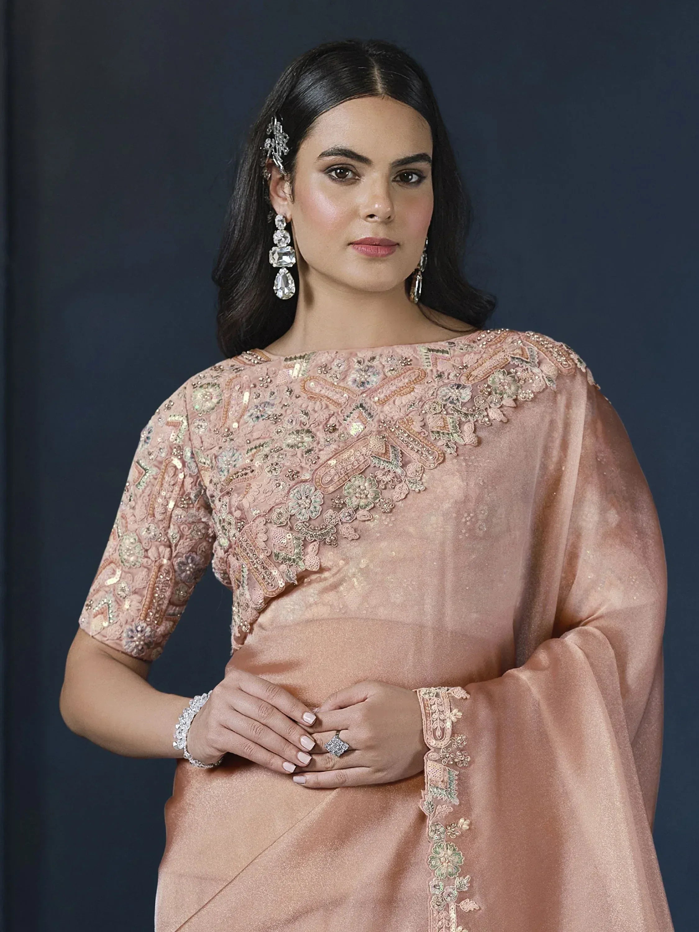 Elegant peach designer saree with intricate floral embroidery and sequin work, perfect for Indian ethnic occasions.