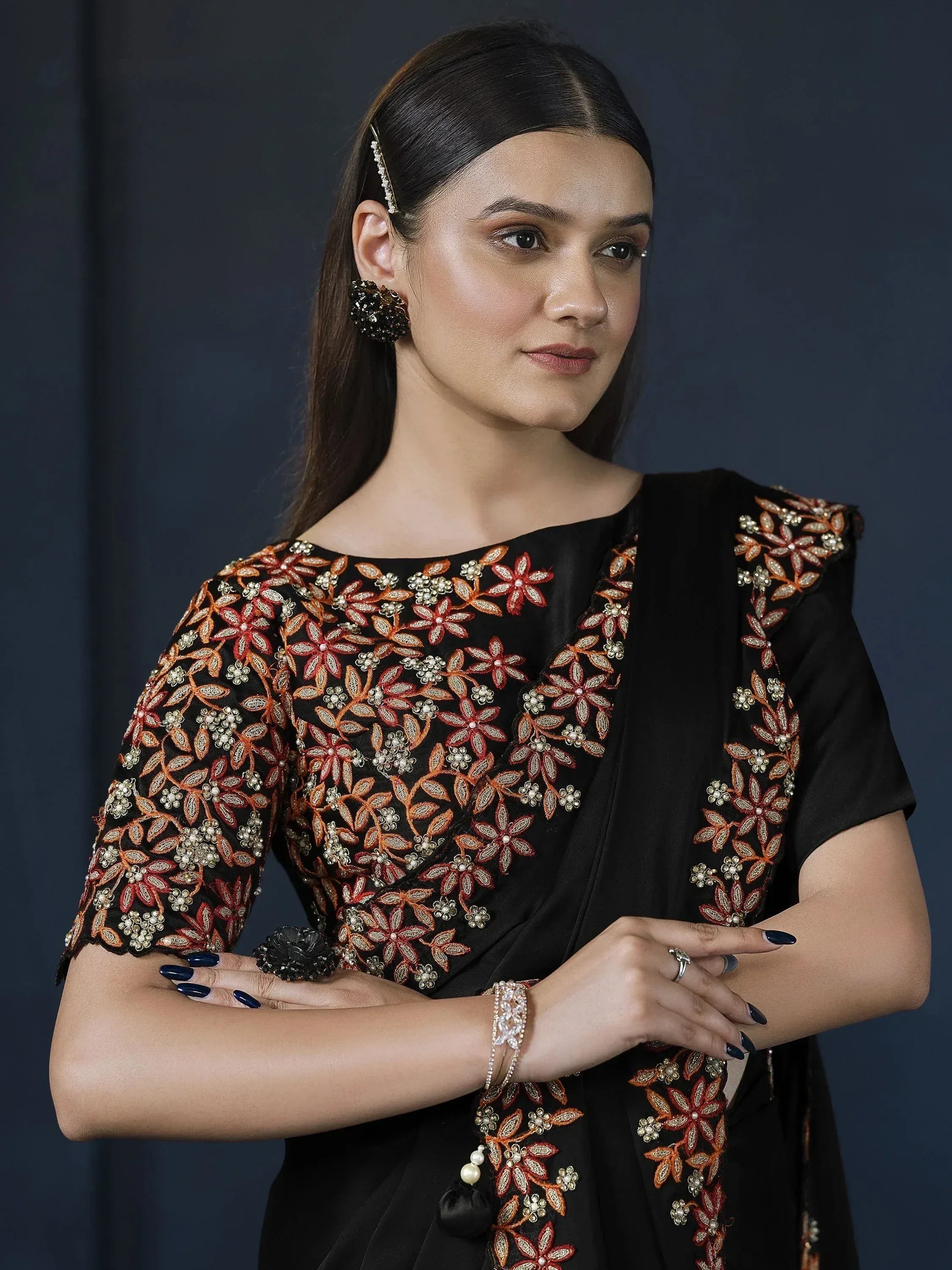 Black ethnic gown with orange floral embroidery, perfect for Indian occasions and festive wear.