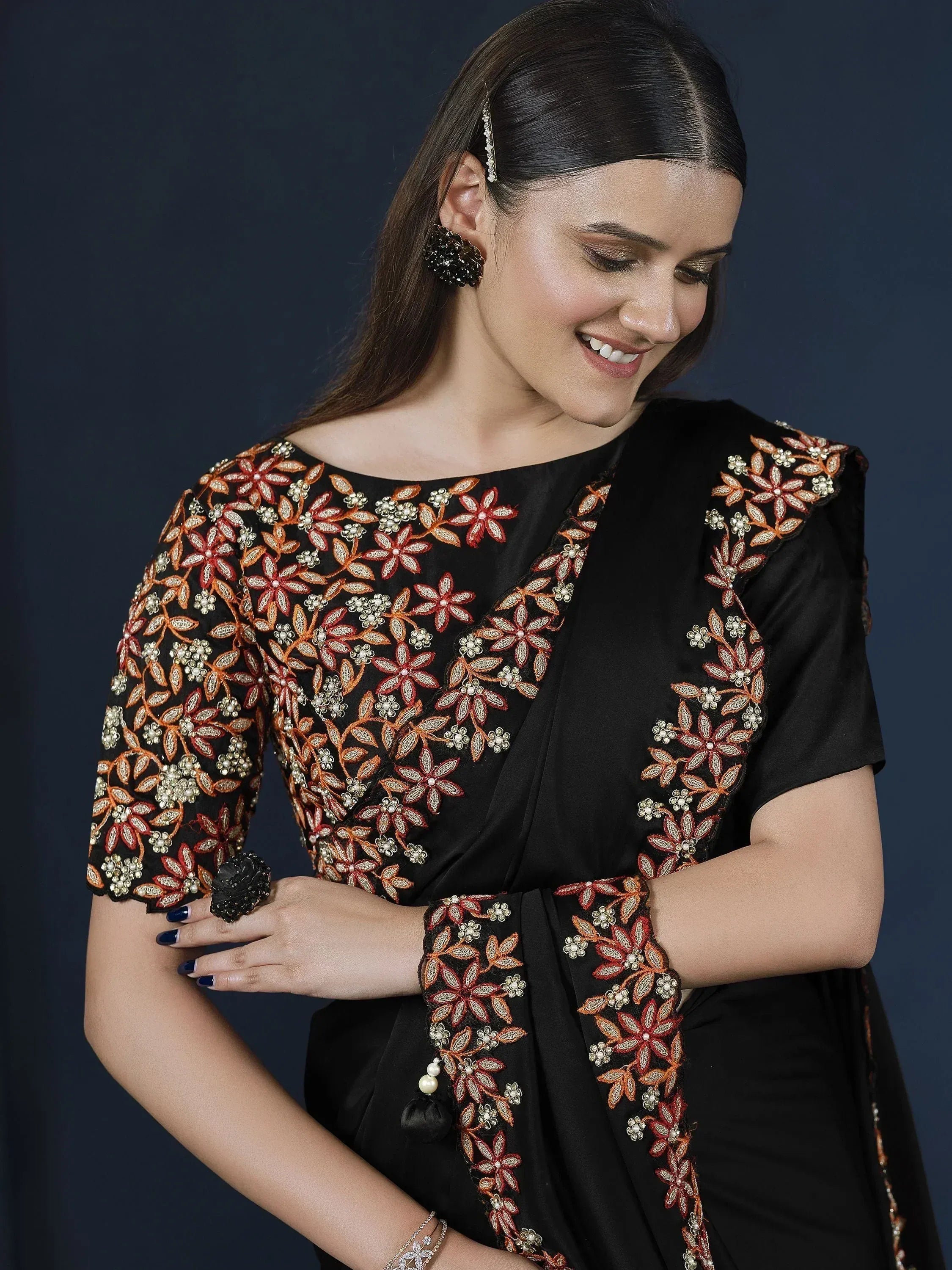 Black ethnic gown with floral embroidery and pearl detailing, perfect for Indian festive occasions.