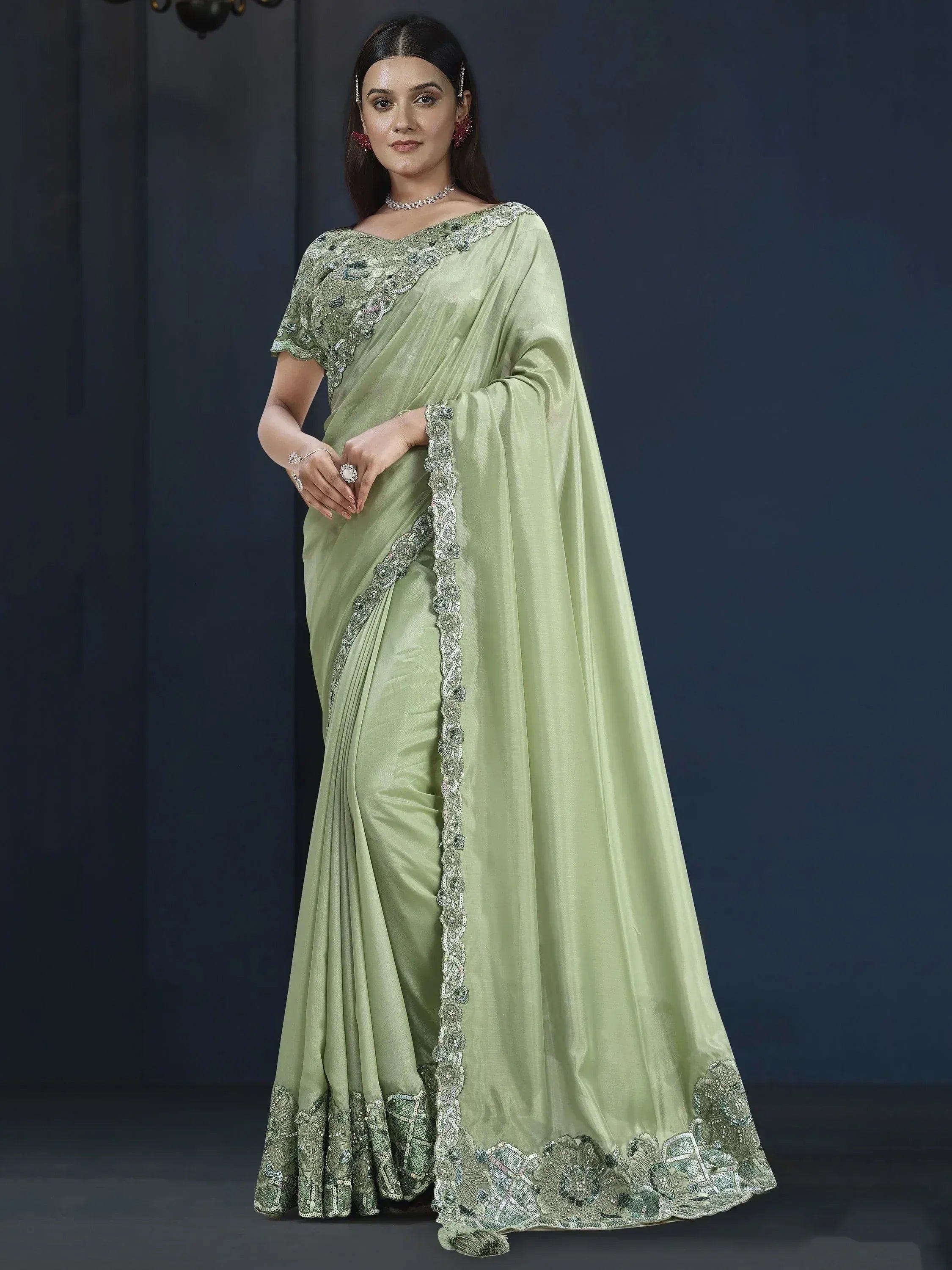 Mint green designer saree with heavy embroidery and sequin work, perfect for weddings and parties.