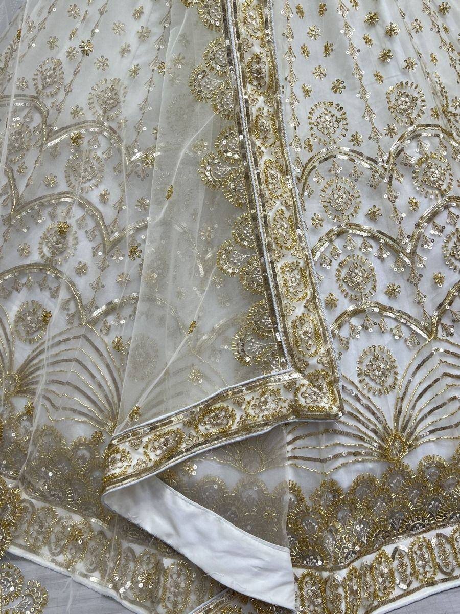 White and gold embroidered lehenga with intricate floral and scalloped detailing, perfect for Indian ethnic wear.