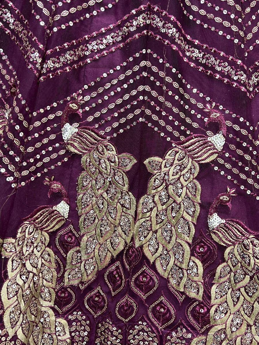 Purple ethnic gown with peacock embroidery and sequin detailing for festive occasions
