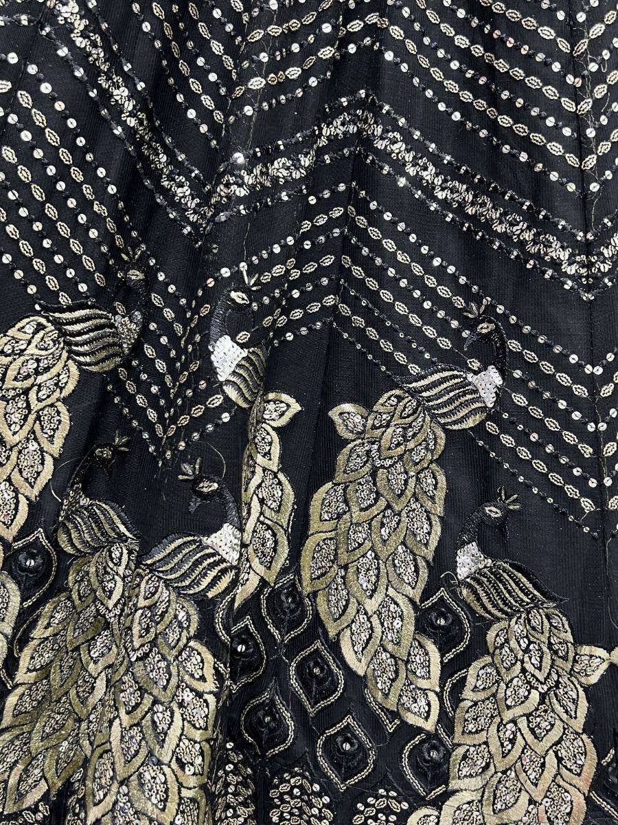 Black ethnic gown with gold peacock embroidery and sequin detailing for festive occasions