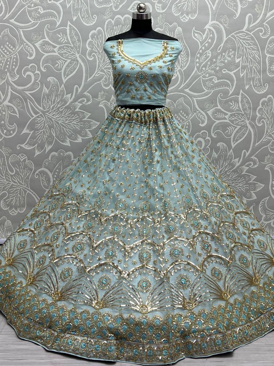 Light blue designer lehenga choli with gold embroidery and peacock motifs, perfect for Indian ethnic wear