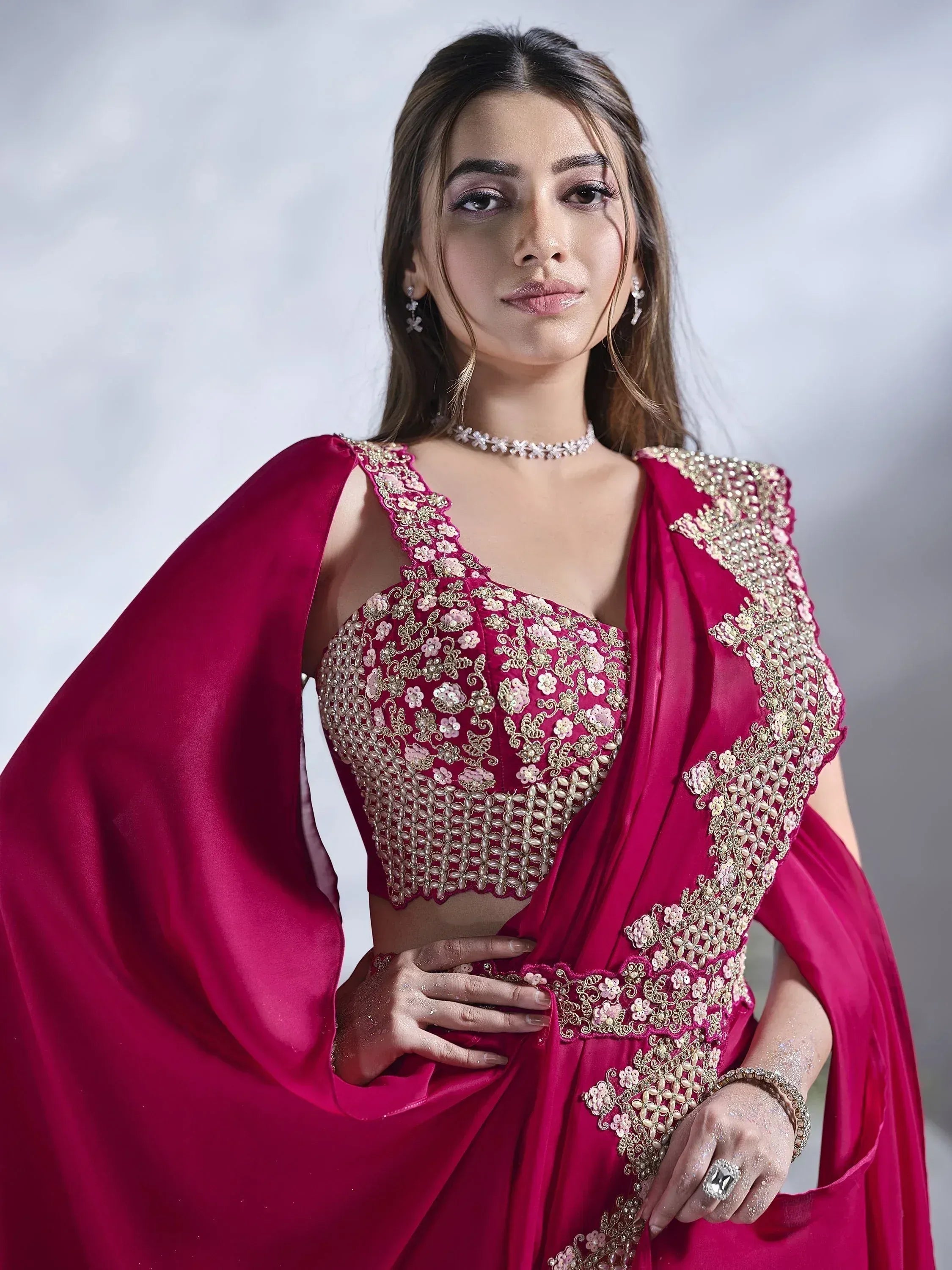 Elegant maroon lehenga choli with gold floral embroidery and cape, perfect for Indian ethnic occasions.
