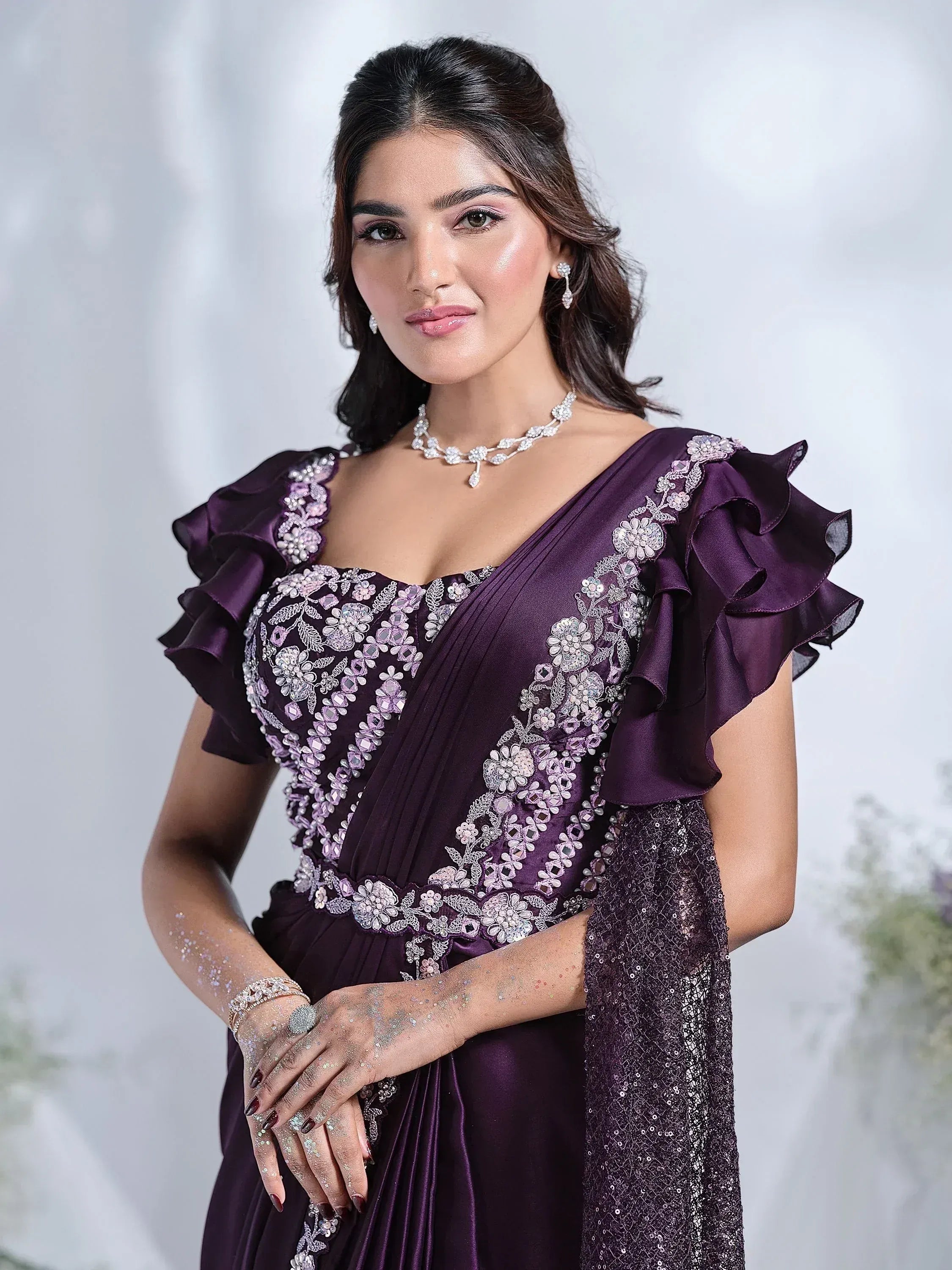 Purple ethnic gown with floral embroidery, ruffle sleeves, and sequin dupatta for Indian occasions