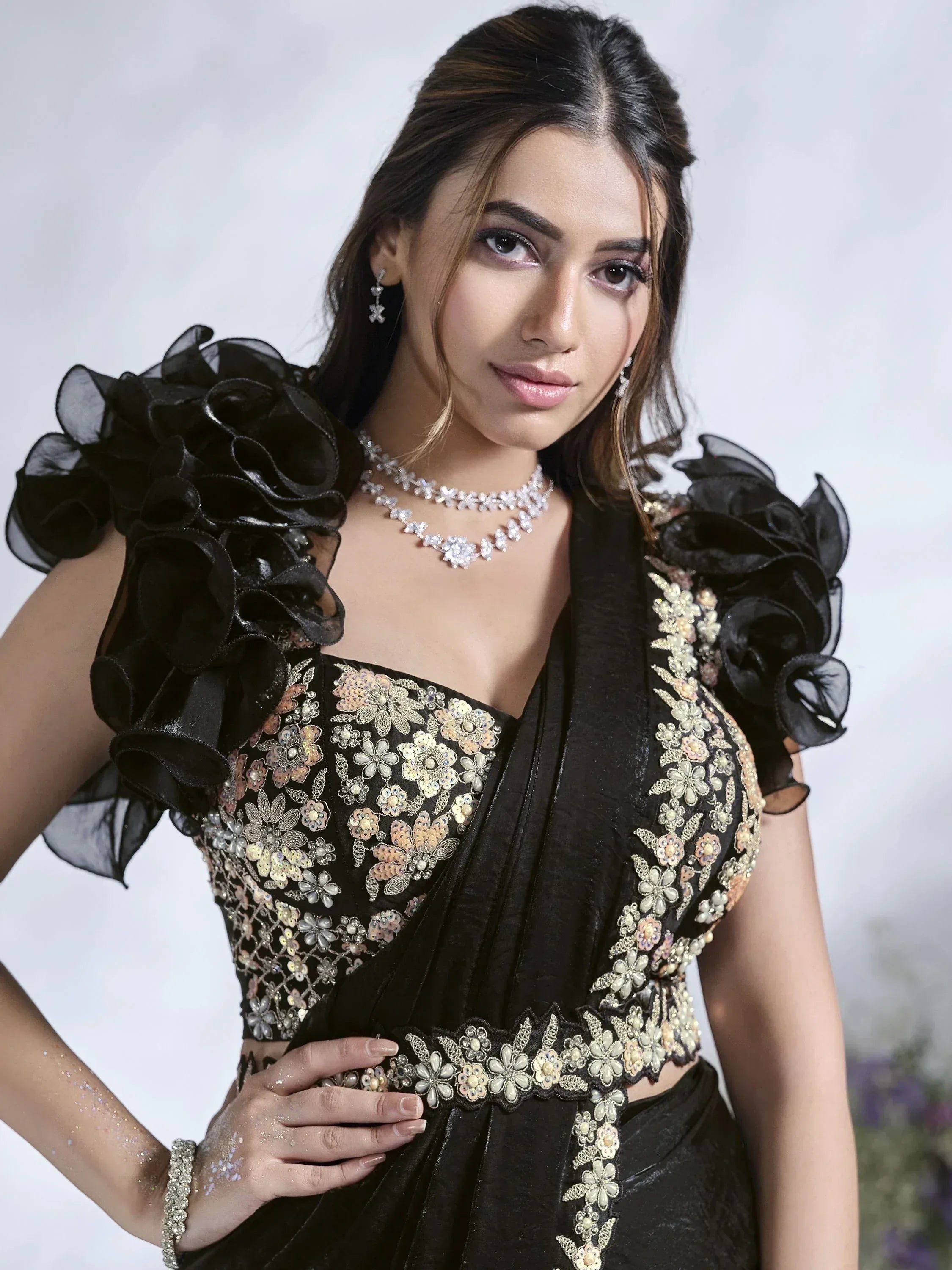Black embroidered saree with floral sequin work and ruffled sleeves, perfect for Indian ethnic occasions