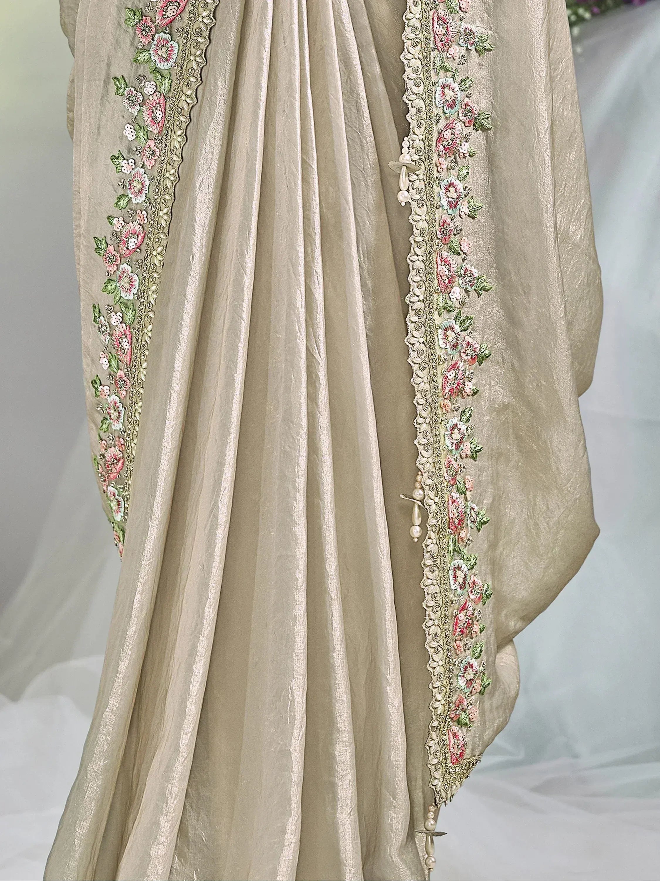 Beige ethnic gown with floral embroidery and pearl detailing, perfect for Indian occasions.