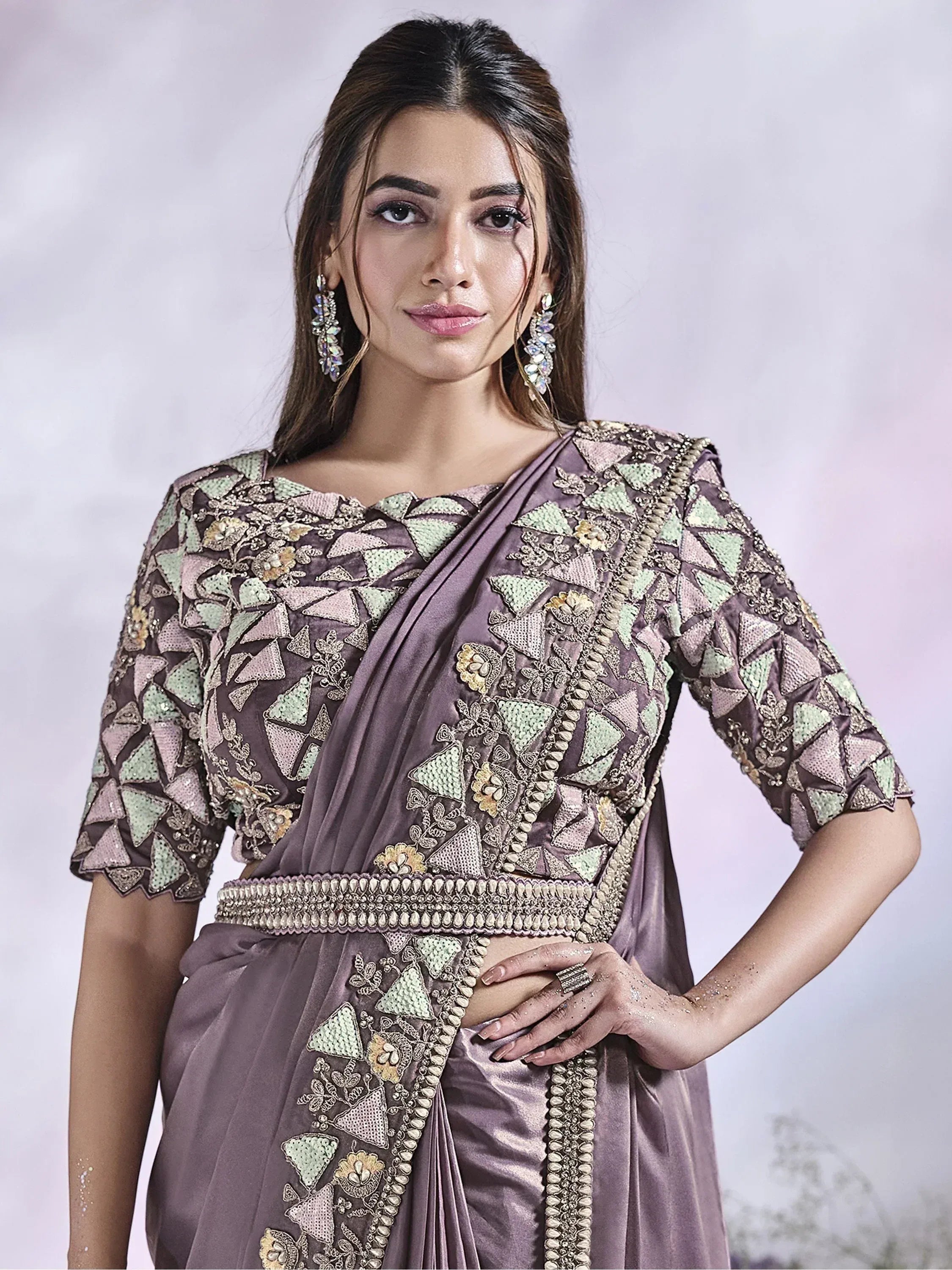 Elegant purple saree with intricate geometric and floral embroidery, perfect for Indian ethnic occasions.
