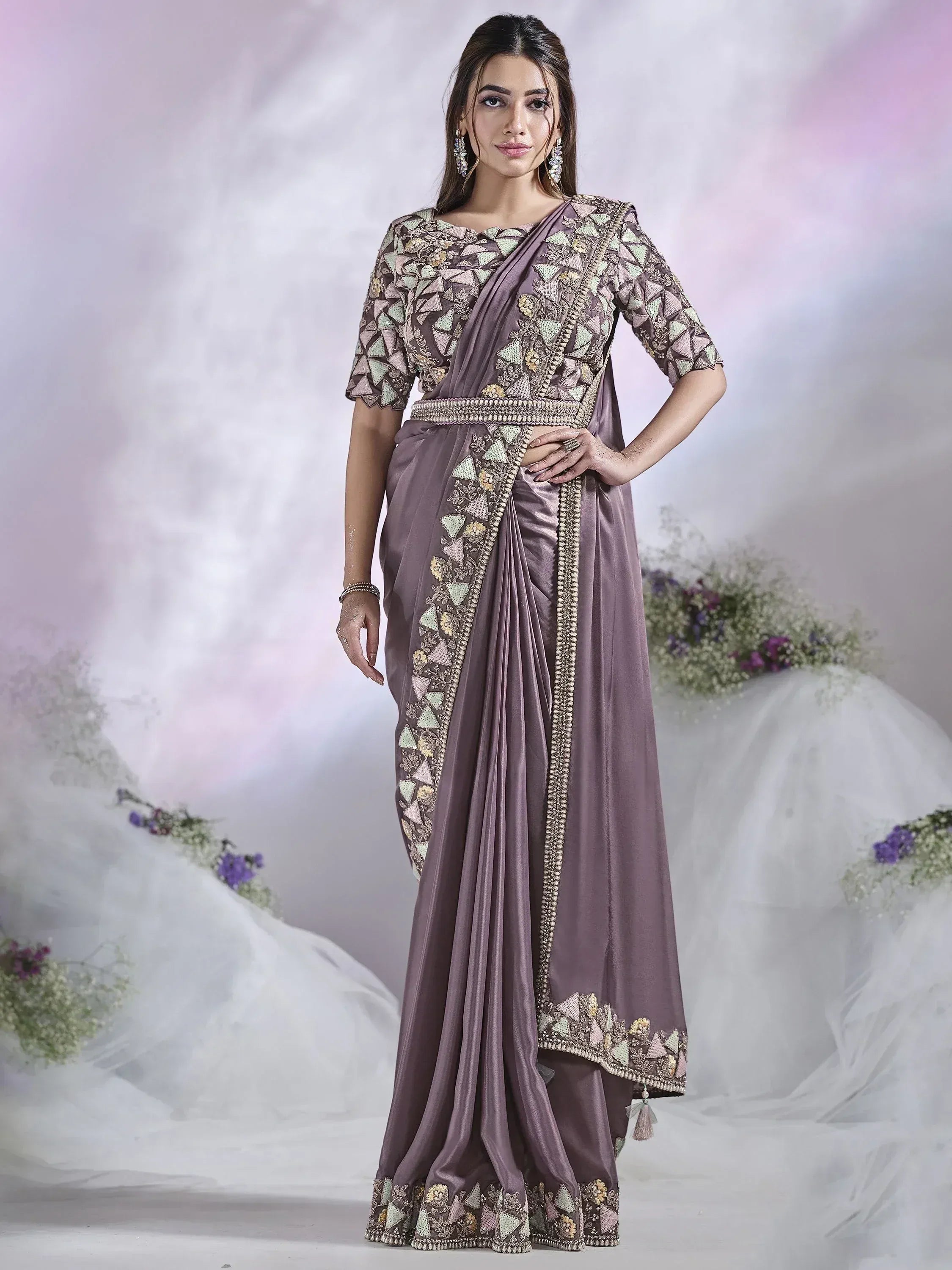 Elegant mauve saree with intricate geometric embroidery and embellished border, perfect for Indian ethnic occasions.