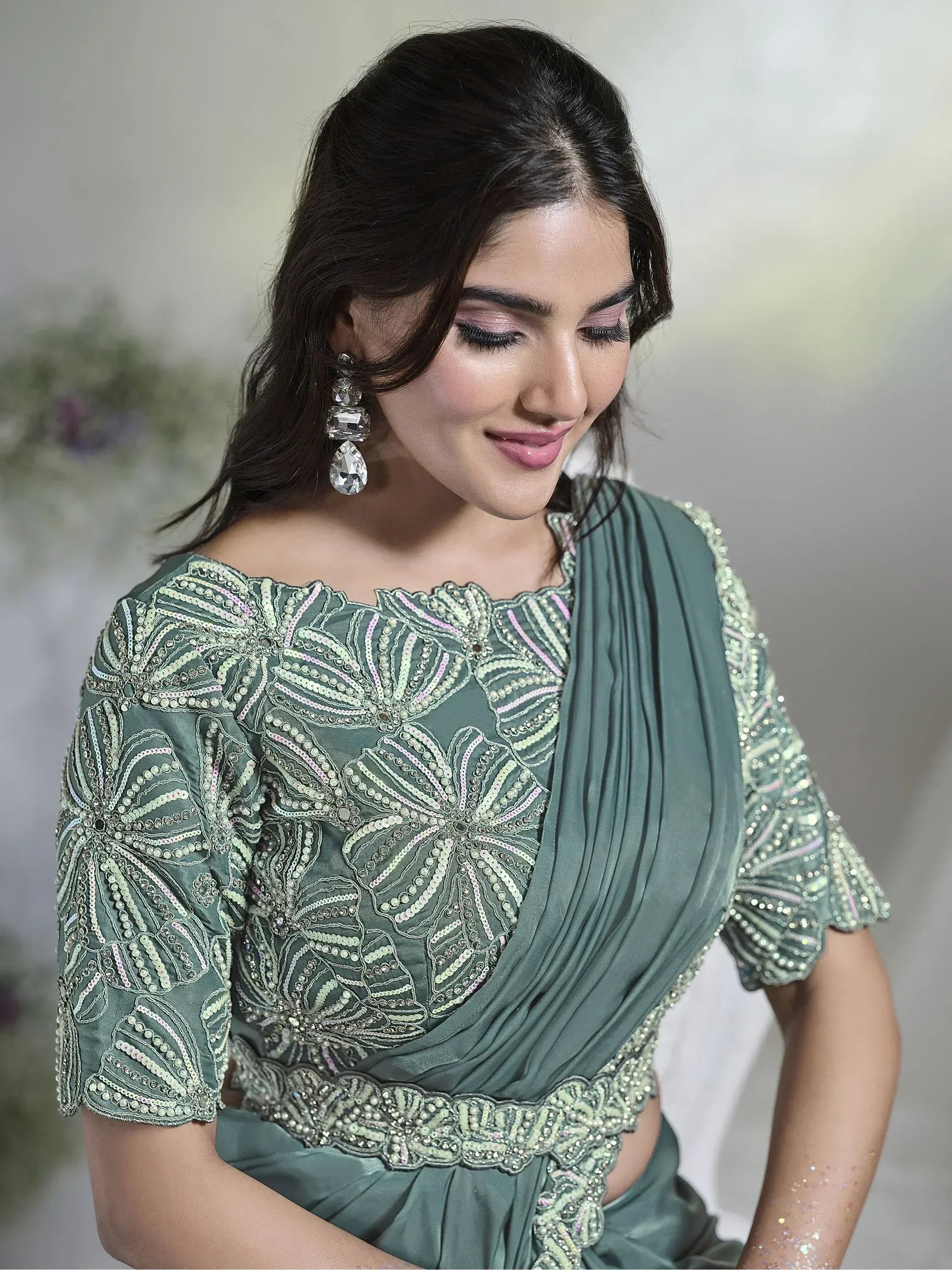 Elegant sage green ethnic gown with intricate floral beadwork and sequin detailing, perfect for Indian occasions.