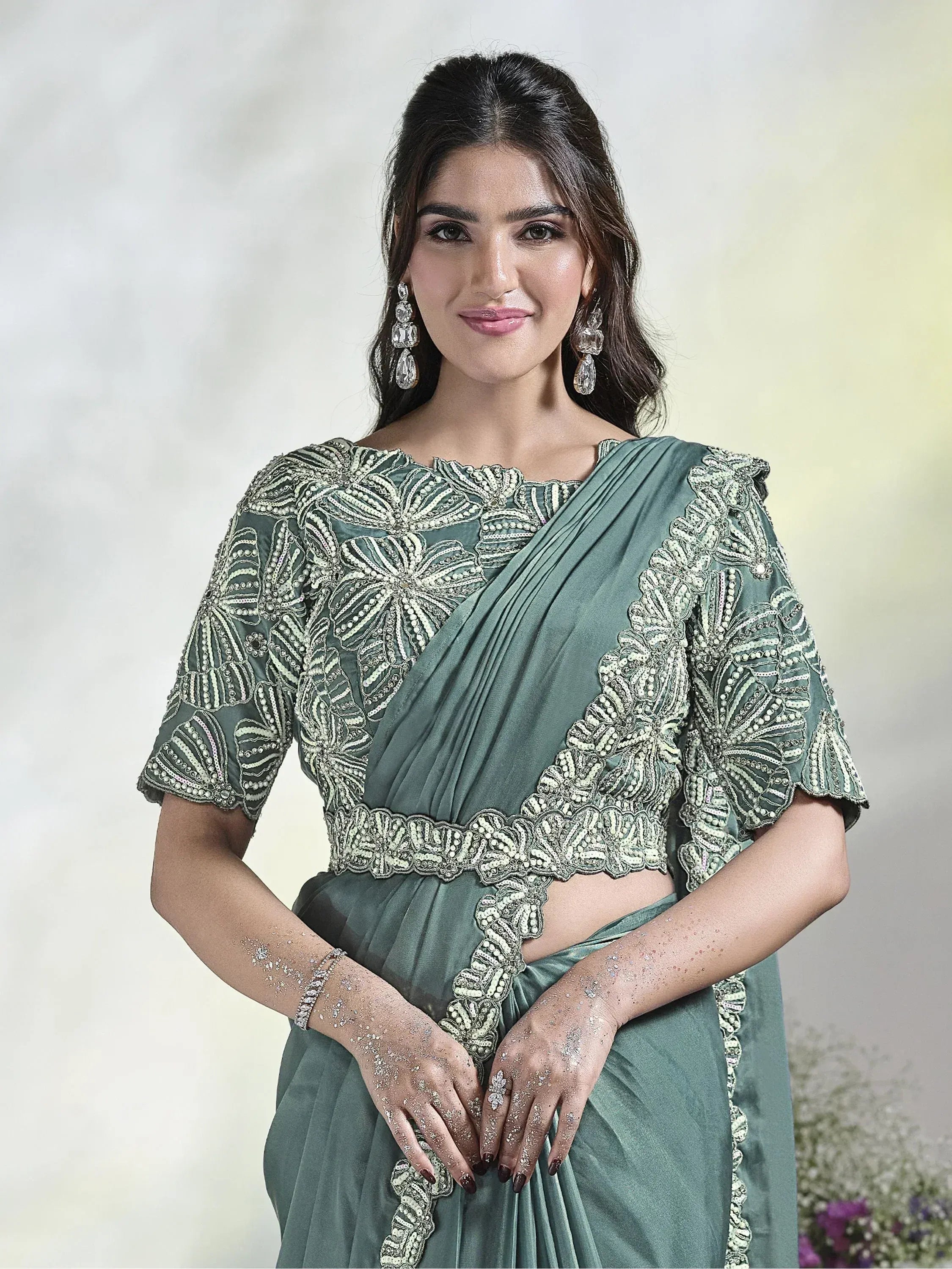 Elegant sage green saree with intricate white embroidery and beaded detailing, perfect for Indian ethnic occasions.
