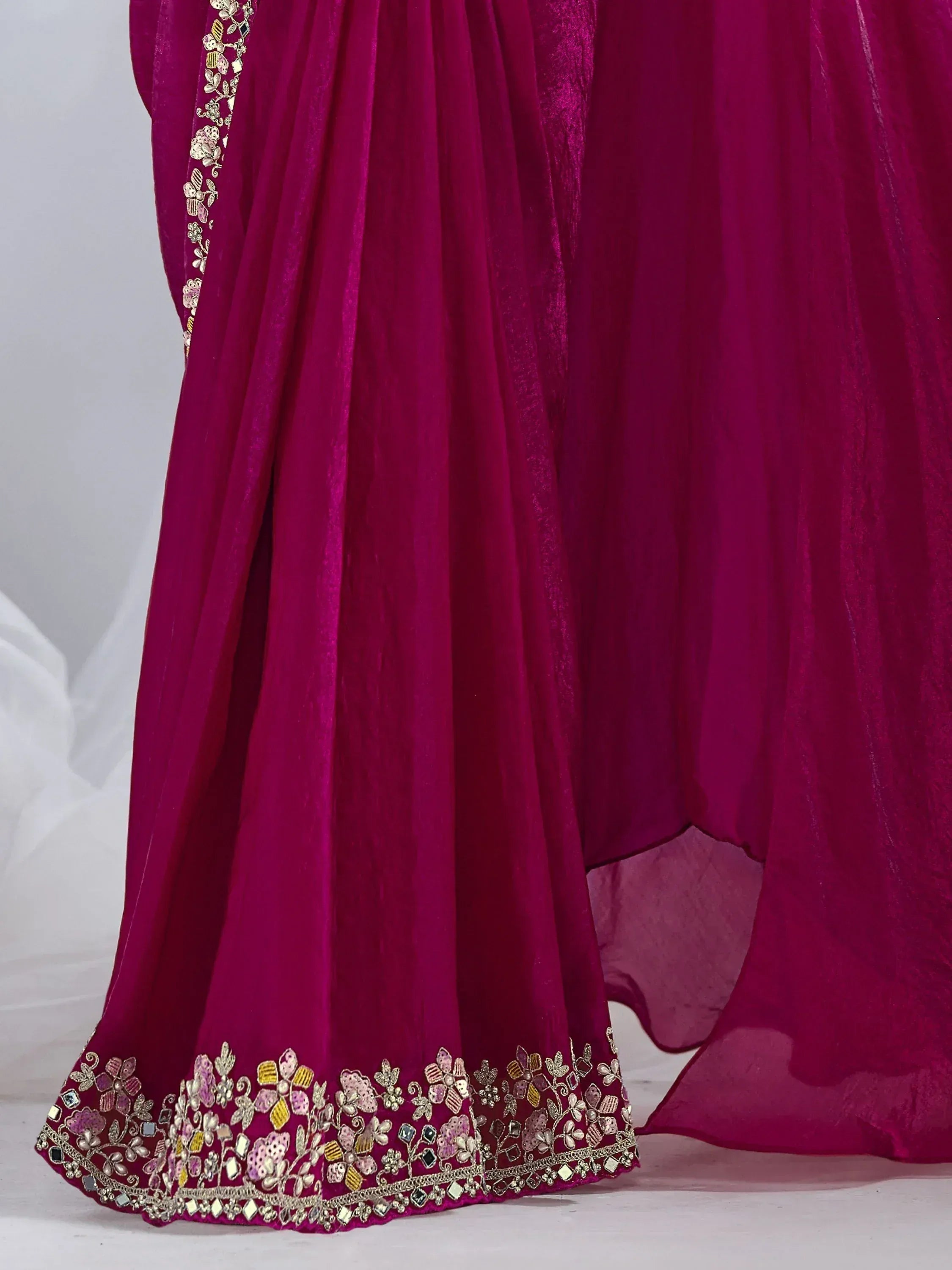Magenta ethnic gown with floral embroidery and mirror work, perfect for Indian celebrations