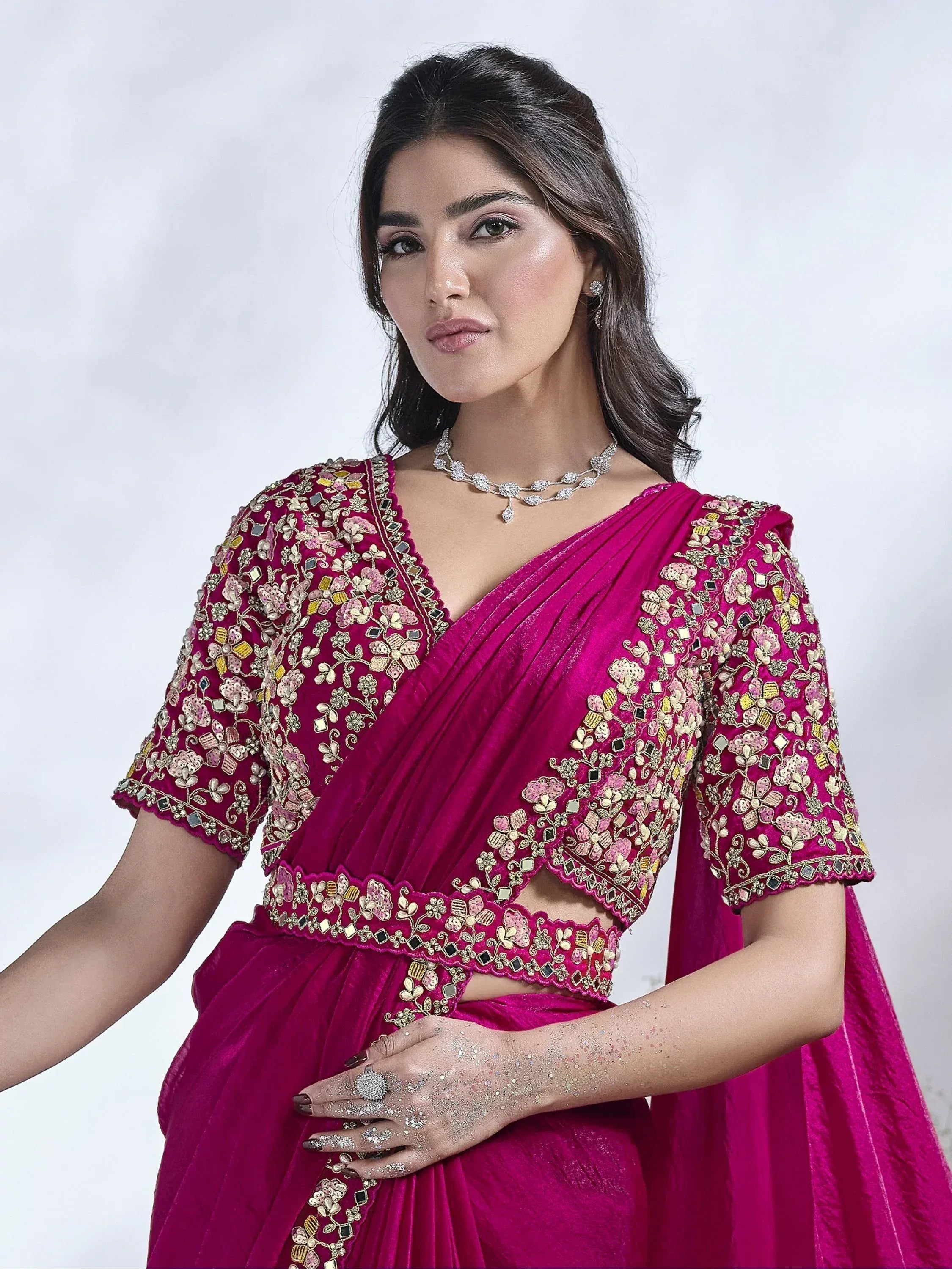 Fuchsia velvet lehenga choli with floral embroidery and mirror work, perfect for Indian weddings and festive occasions.