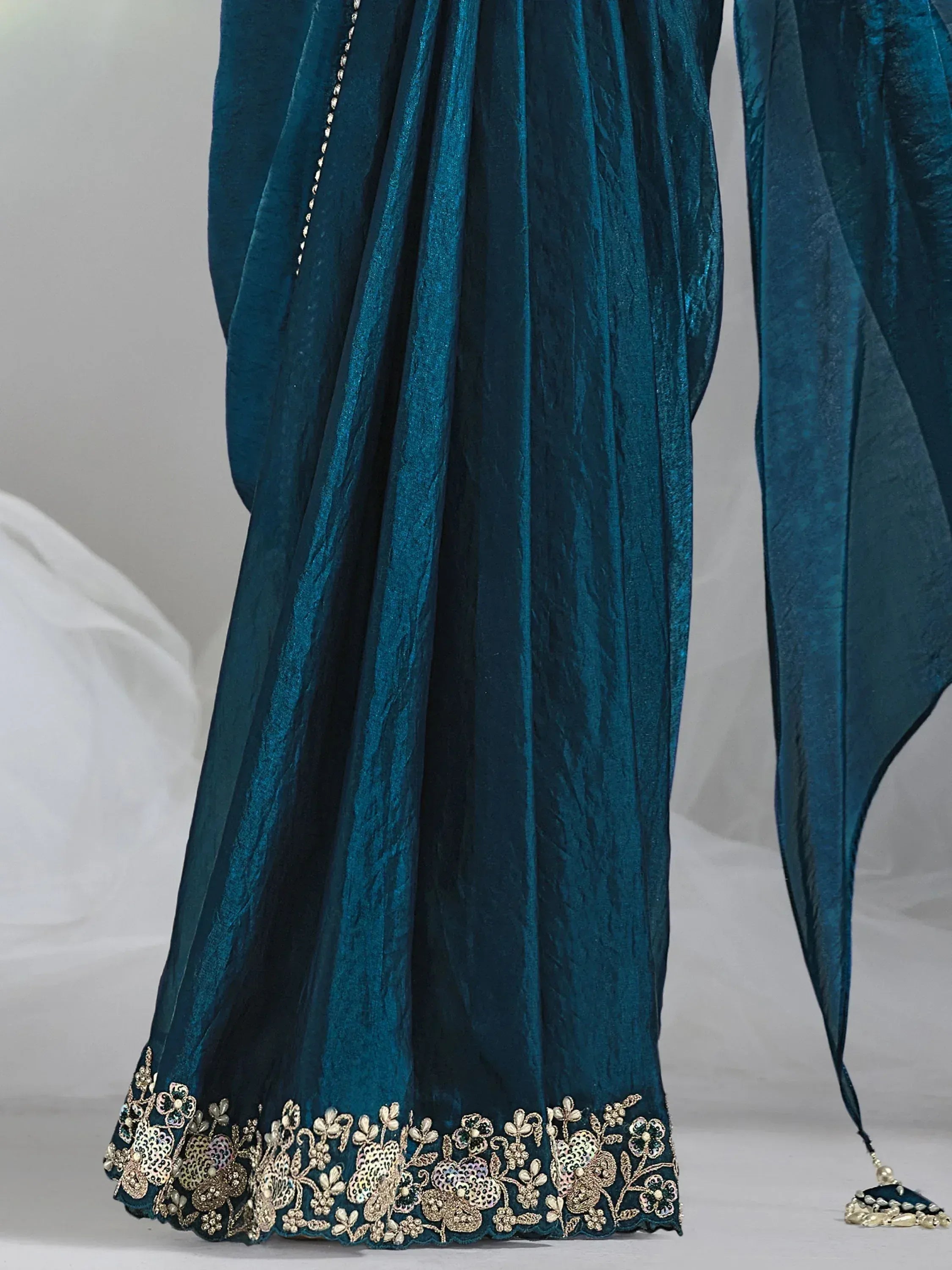 Teal velvet ethnic gown with gold floral embroidery, perfect for Indian celebrations and weddings.