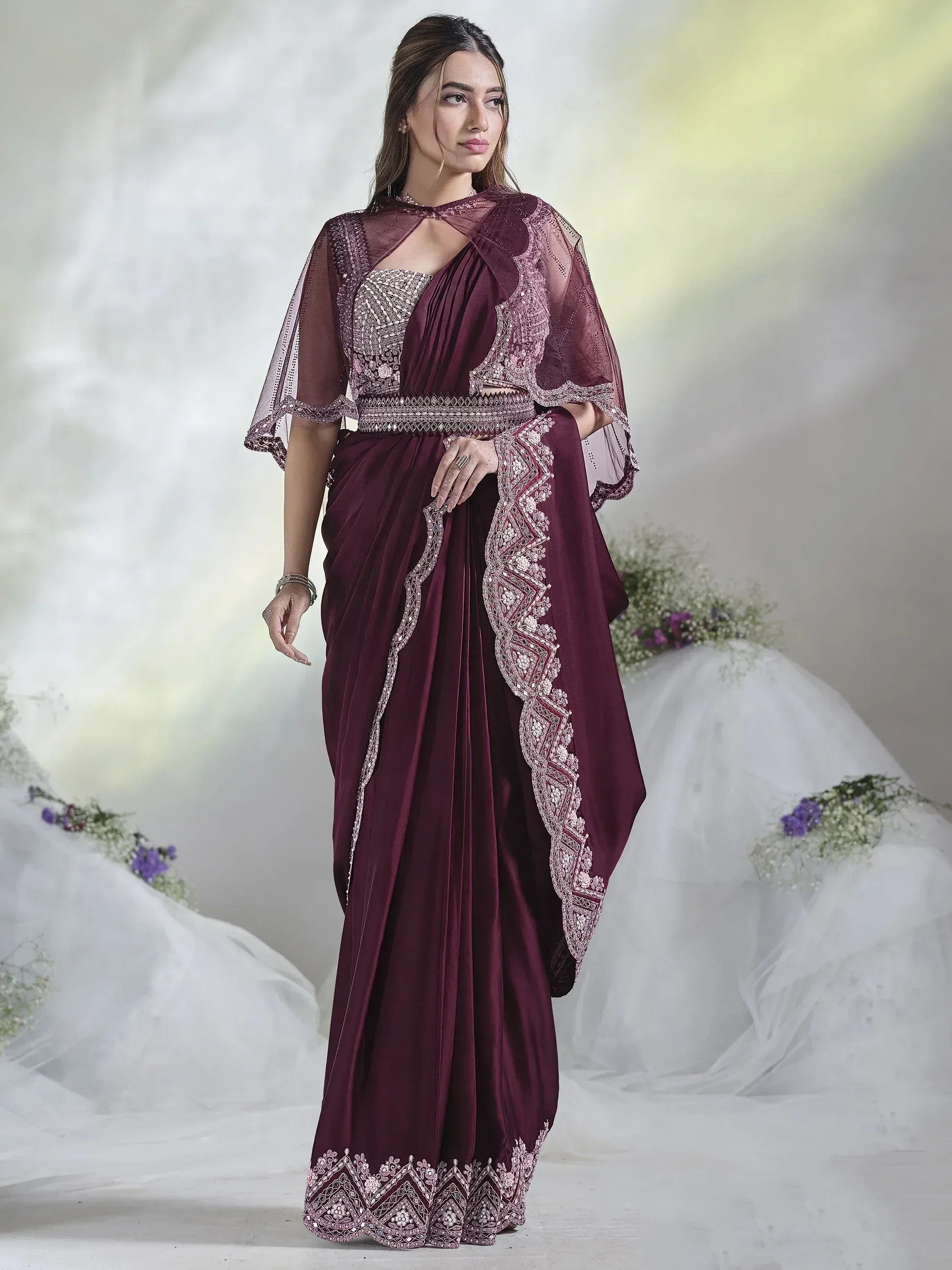 Elegant maroon saree with intricate embroidery and sheer cape, perfect for Indian ethnic occasions.