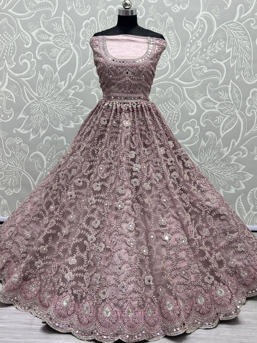 Dusty pink embroidered lehenga choli with floral motifs and mirror work, displayed on mannequin
