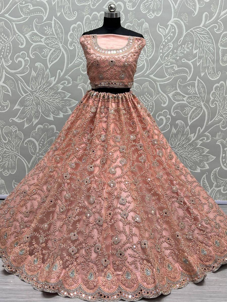Pink designer lehenga choli with heavy embroidery and mirror work, perfect for weddings and festivals