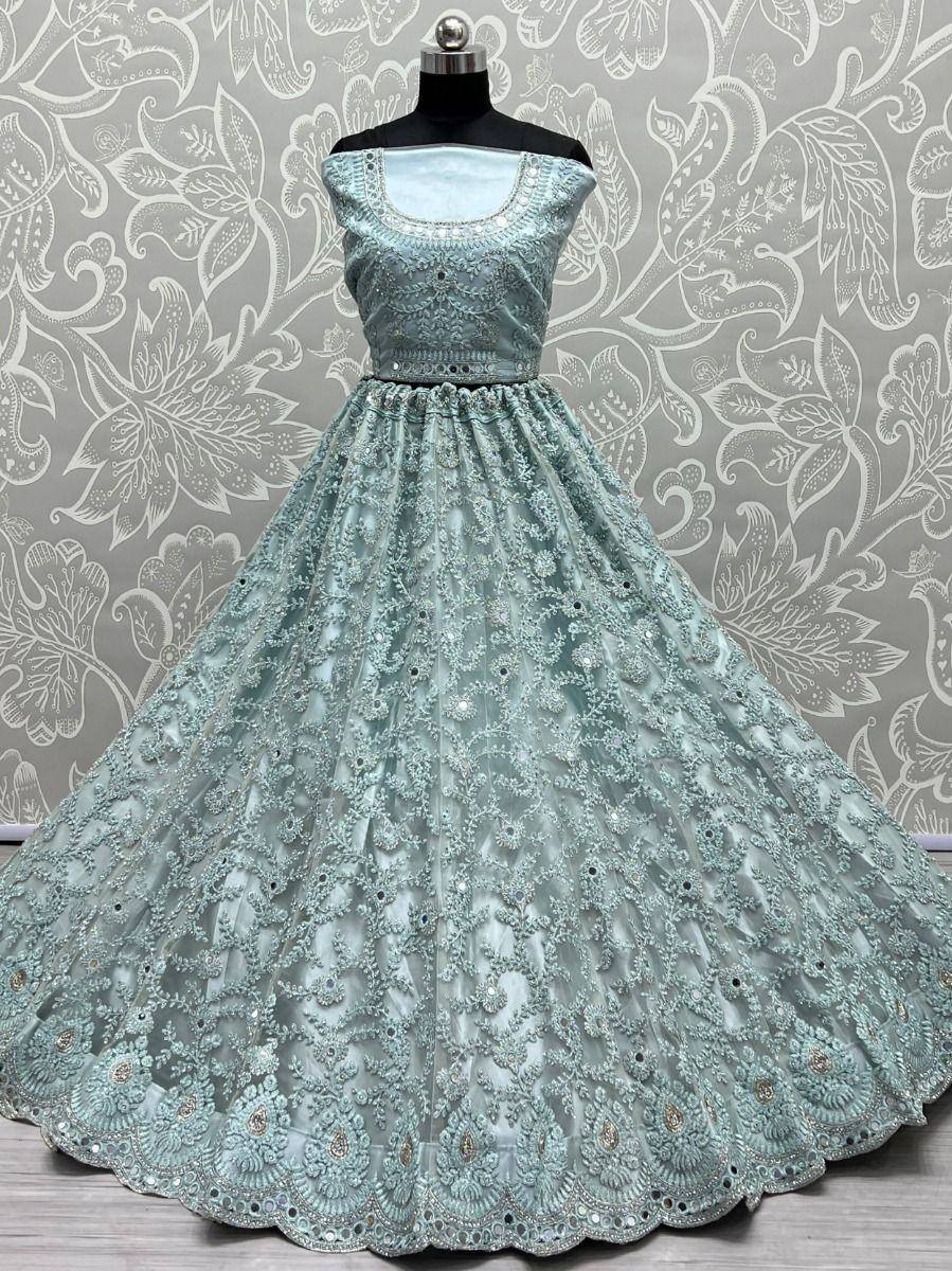 Mint green designer lehenga choli with heavy embroidery and scalloped hem, perfect for weddings and festivals