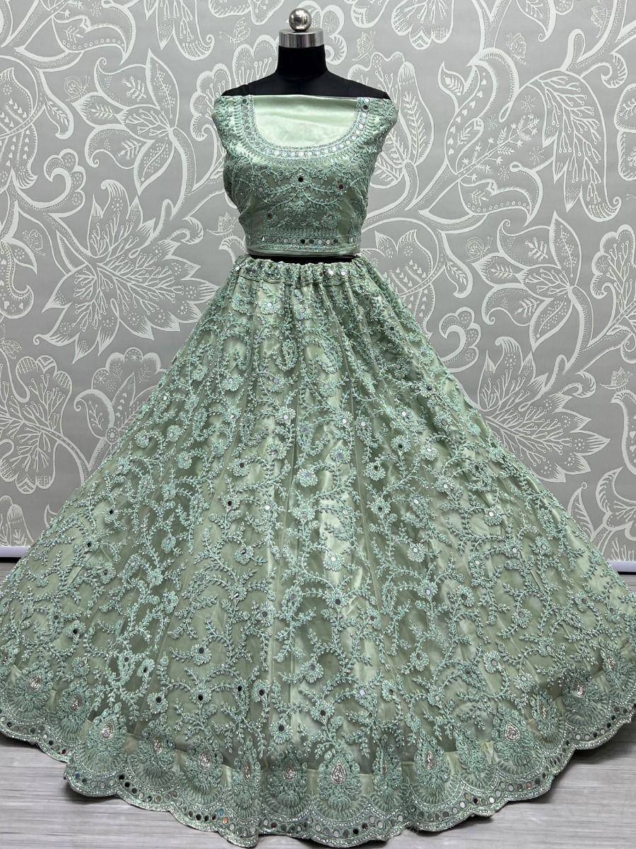 Mint green designer lehenga choli with intricate embroidery and sequin work, perfect for weddings and festivals.