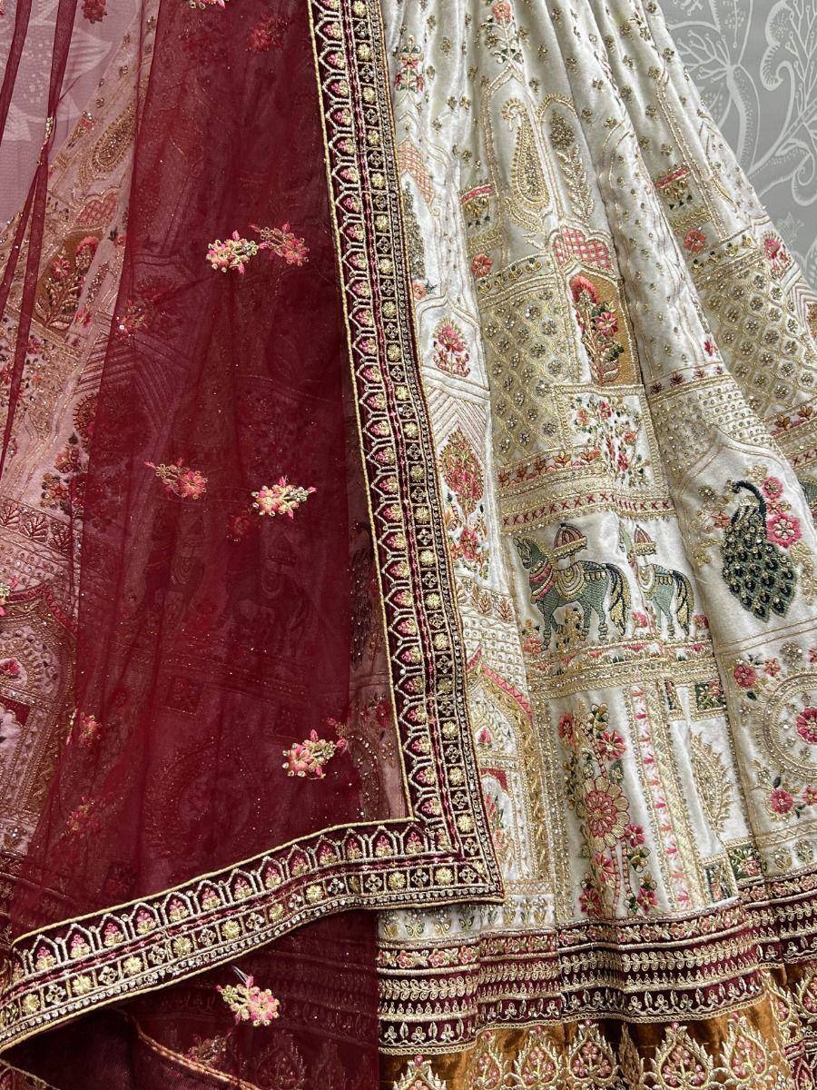 Designer lehenga choli with intricate embroidery, peacock and horse motifs, maroon dupatta, ethnic Indian wear