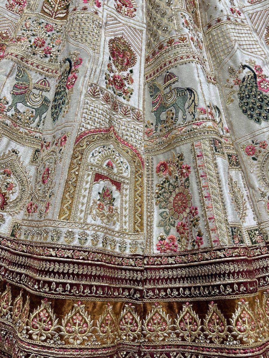 Designer lehenga with intricate horse, peacock & floral embroidery in gold and pink tones