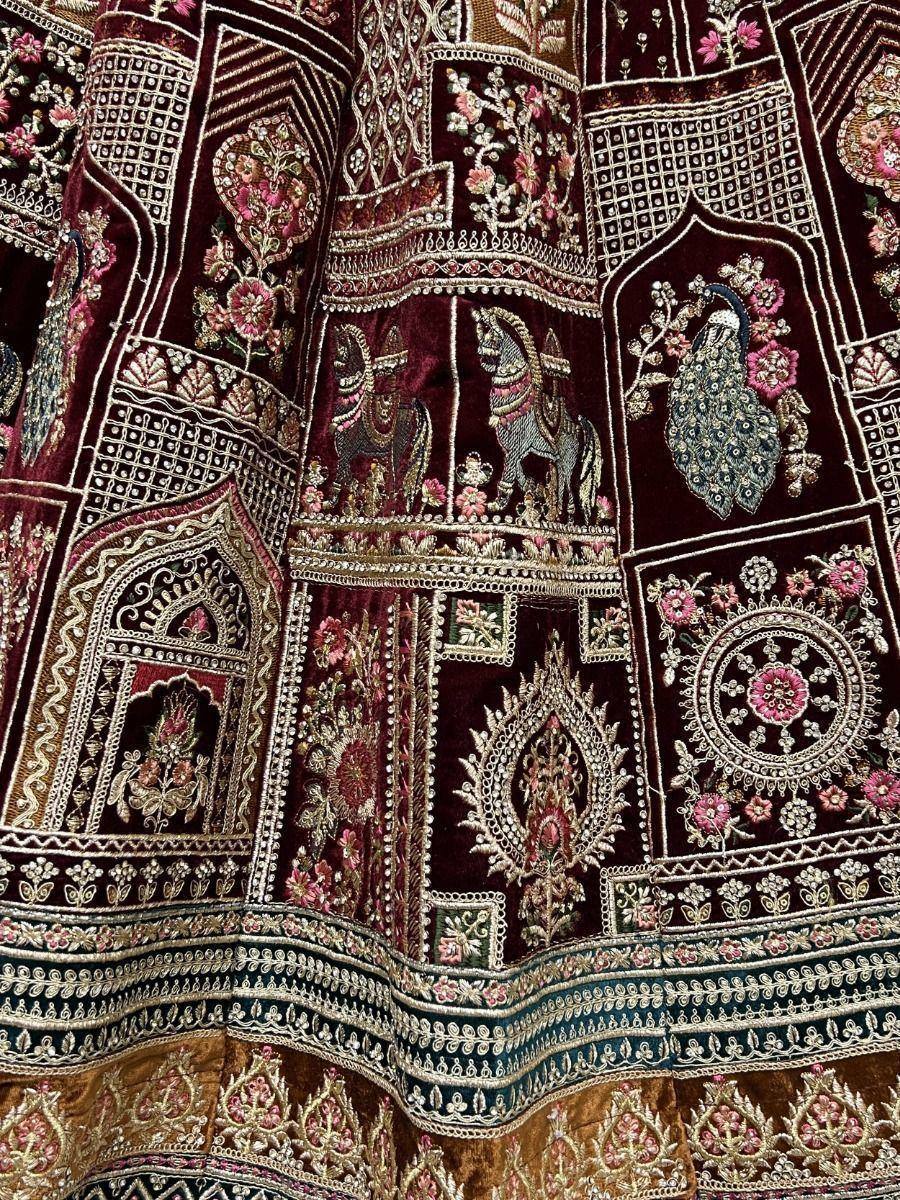 Richly embroidered maroon lehenga with peacock, horse motifs and floral zari work for Indian ethnic wear