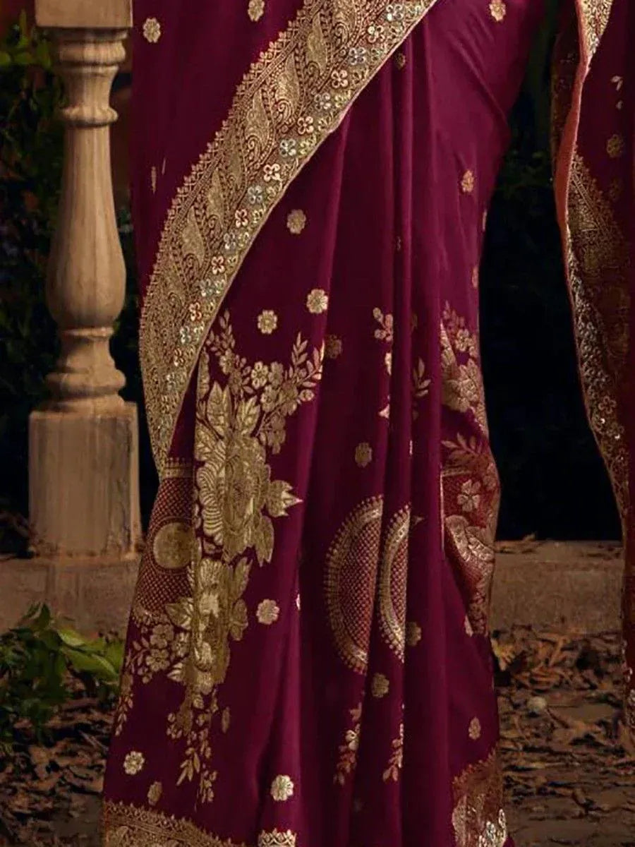 Rich maroon saree with gold floral embroidery and ornate border, ideal for ethnic occasions