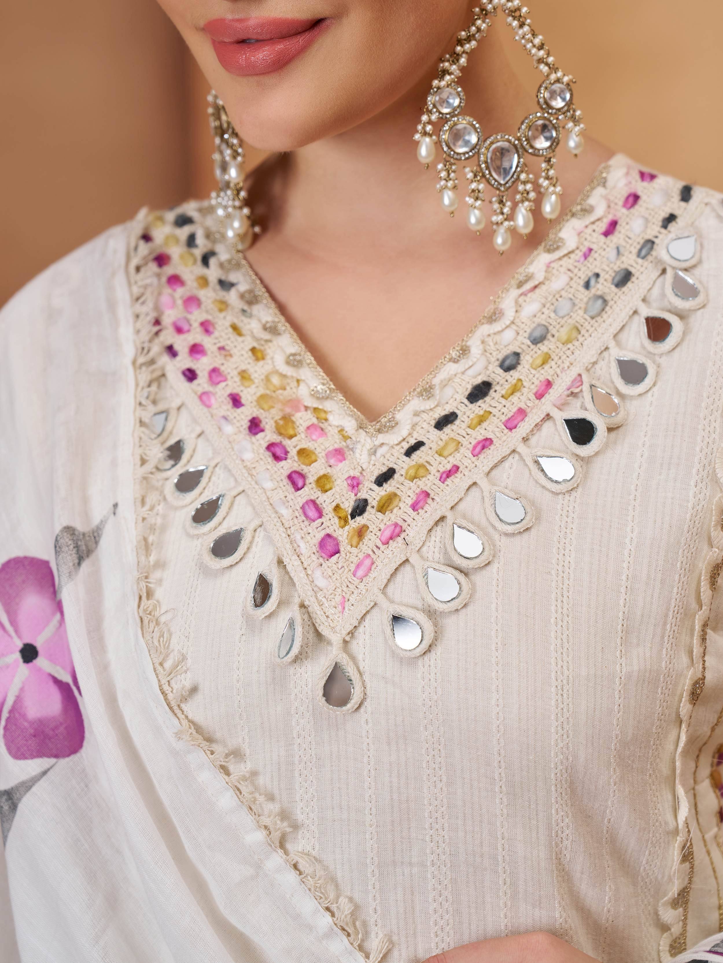 Cream ethnic kurta with mirror and thread embroidery, paired with pearl jewelry