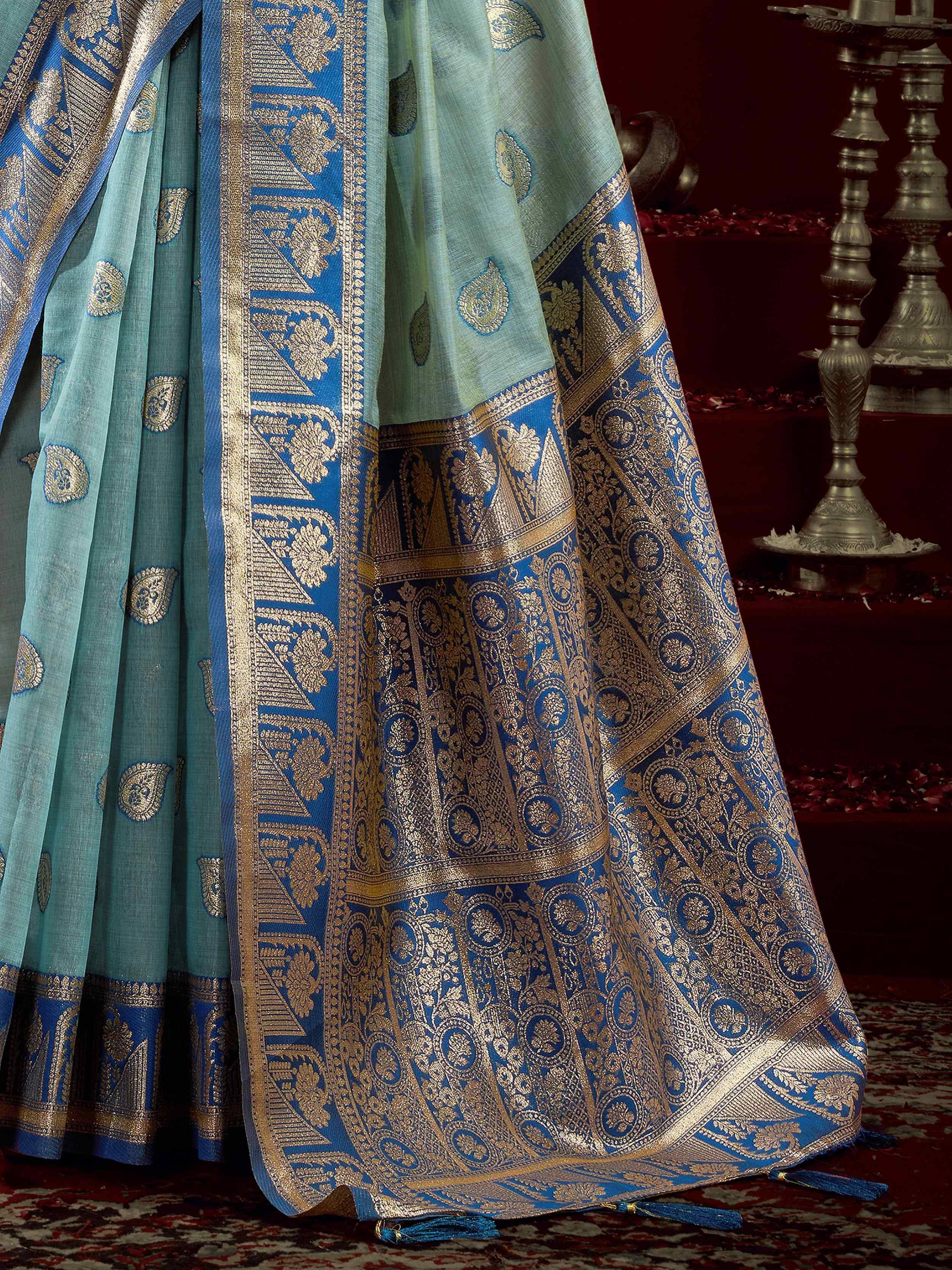Blue and gold embroidered saree with intricate paisley and floral designs, perfect for ethnic occasions.