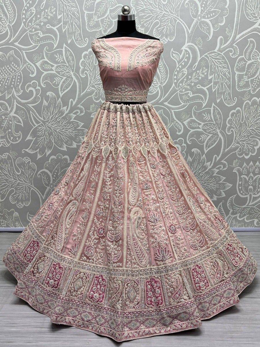 Pink designer lehenga choli with intricate embroidery and paisley patterns, perfect for Indian weddings and festivals.