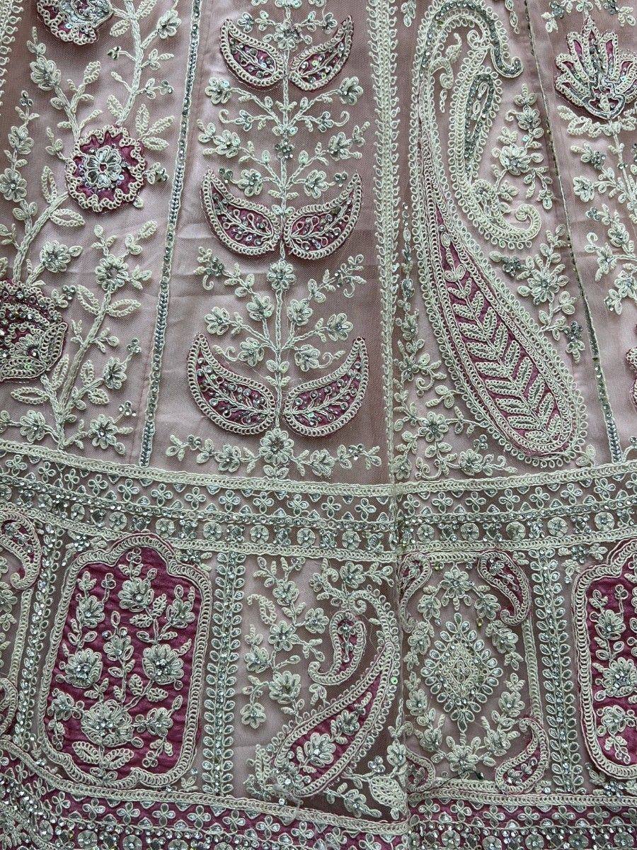 Pink and silver embroidered lehenga choli with floral and paisley motifs, perfect for Indian ethnic wear.