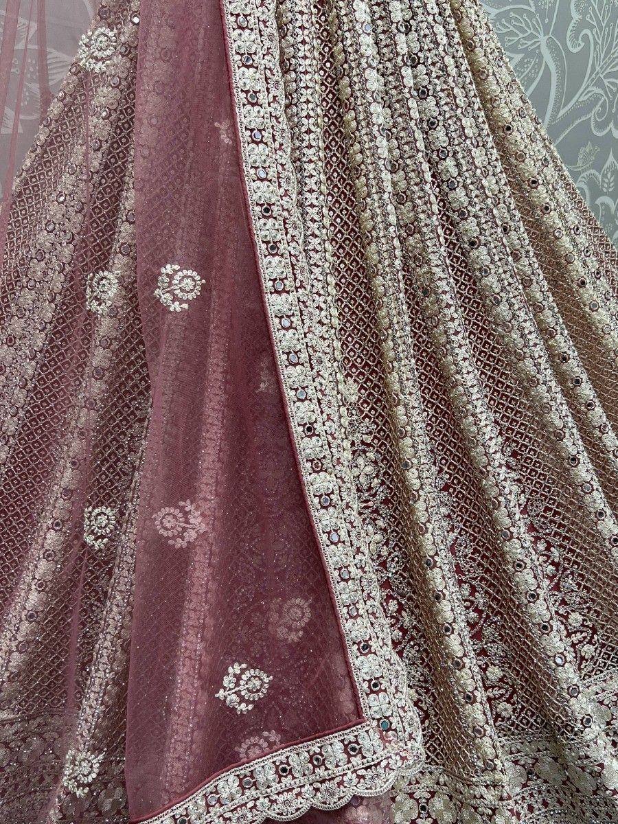 Maroon designer lehenga choli with intricate gold embroidery and mirror work, perfect for weddings
