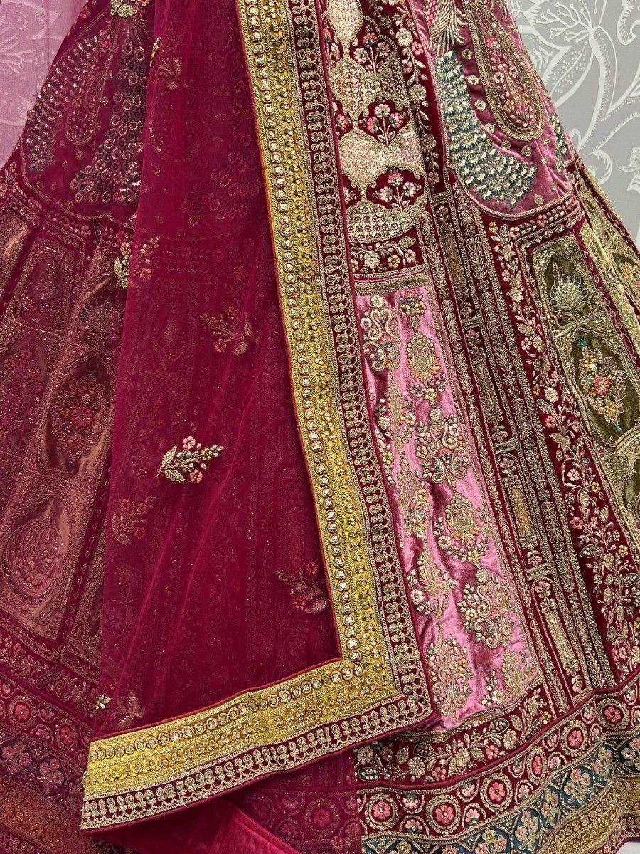 Luxury maroon lehenga with gold embroidery and pink velvet panel, perfect for Indian weddings and festive occasions.