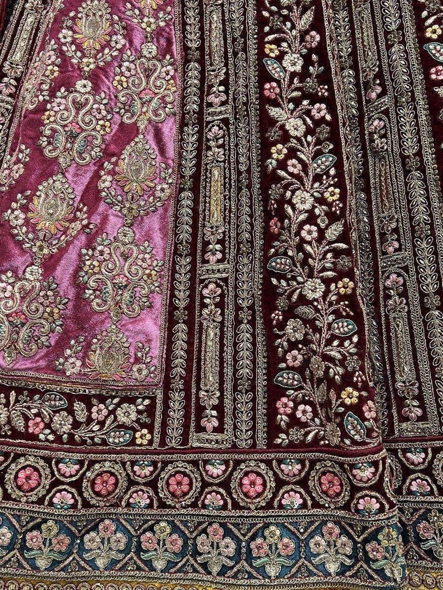 Luxury velvet lehenga with intricate floral embroidery and zari work, perfect for Indian ethnic wear occasions.