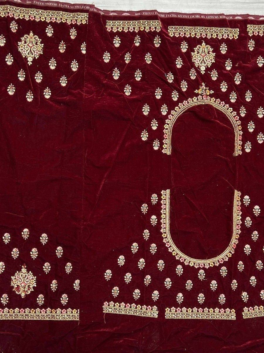 Maroon velvet ethnic blouse with intricate gold and pink embroidery, perfect for Indian weddings or festive occasions.