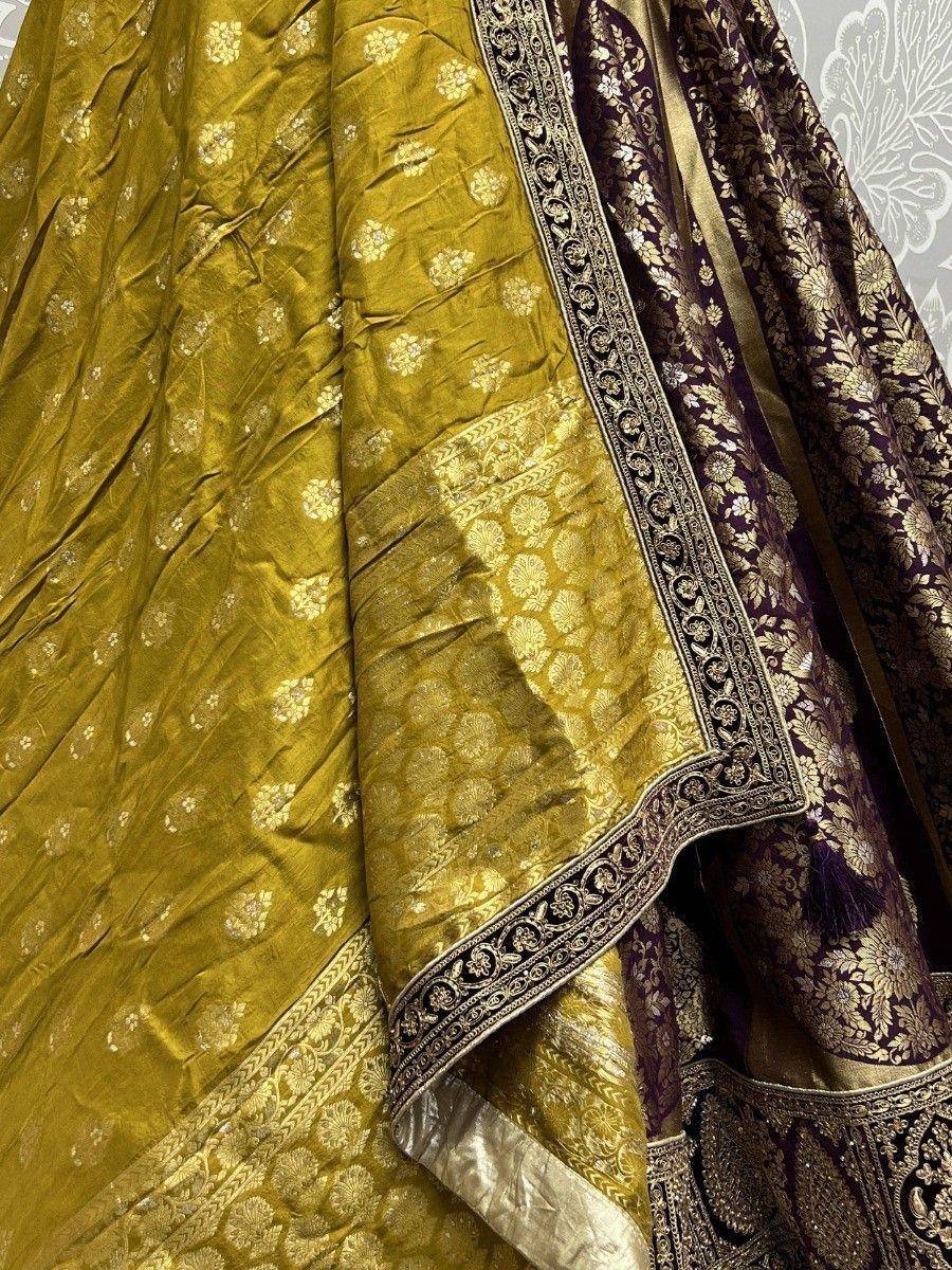 Golden and purple ethnic lehenga choli with intricate floral embroidery and zari work