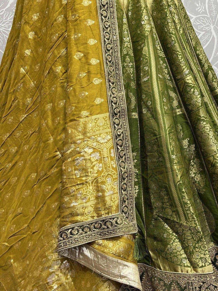 Luxury green and gold embroidered lehenga choli with intricate floral zari work and velvet texture
