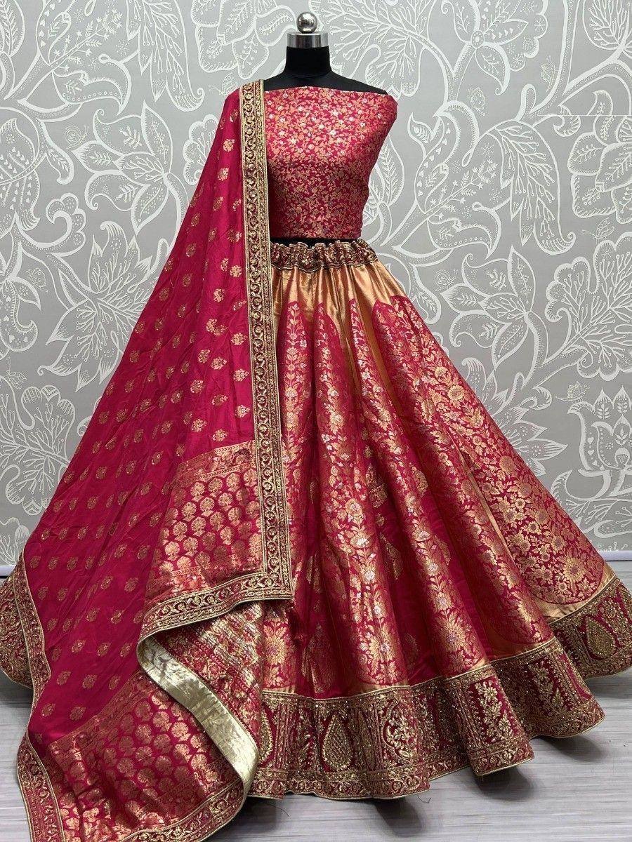 Red and gold designer lehenga choli with intricate embroidery and matching dupatta, perfect for weddings and festive occasions.