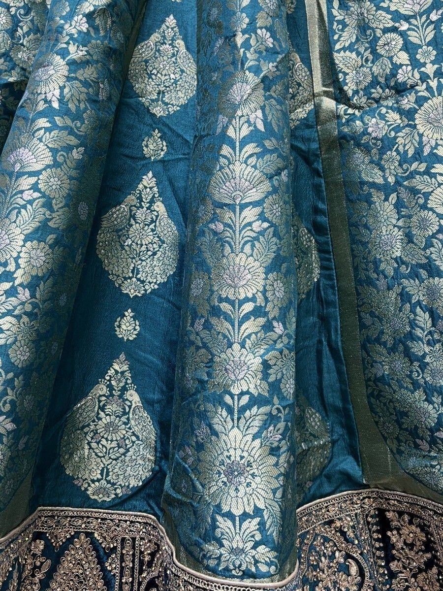 Teal blue designer lehenga with intricate gold floral embroidery and heavy border detailing