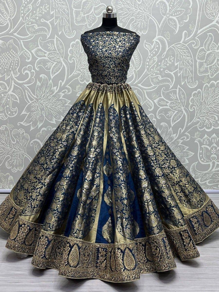 Blue and gold embroidered lehenga choli with floral motifs, perfect for Indian weddings and festive occasions.