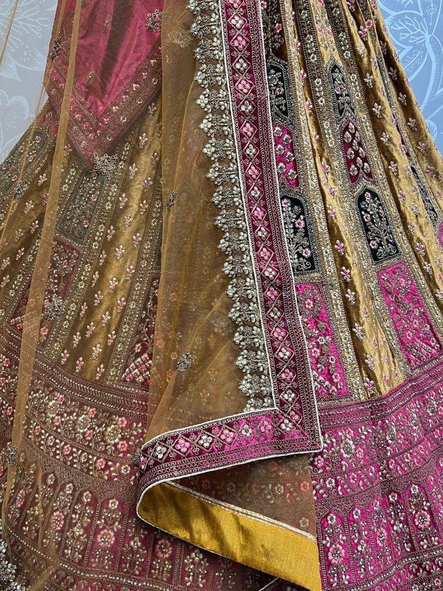 Luxury gold and pink embroidered lehenga choli with intricate floral zari work and net dupatta