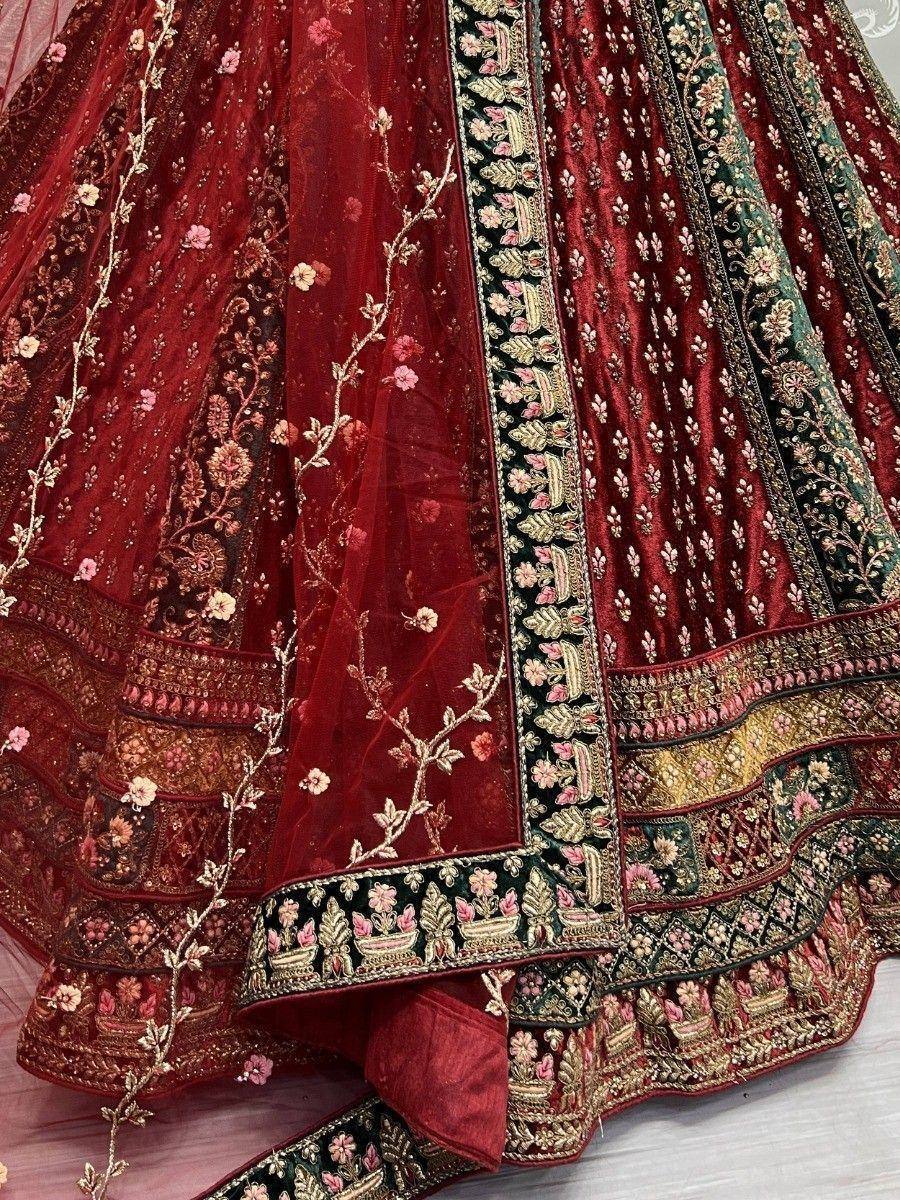 Rich maroon lehenga choli with floral embroidery and velvet detailing, perfect for Indian weddings and festive occasions.