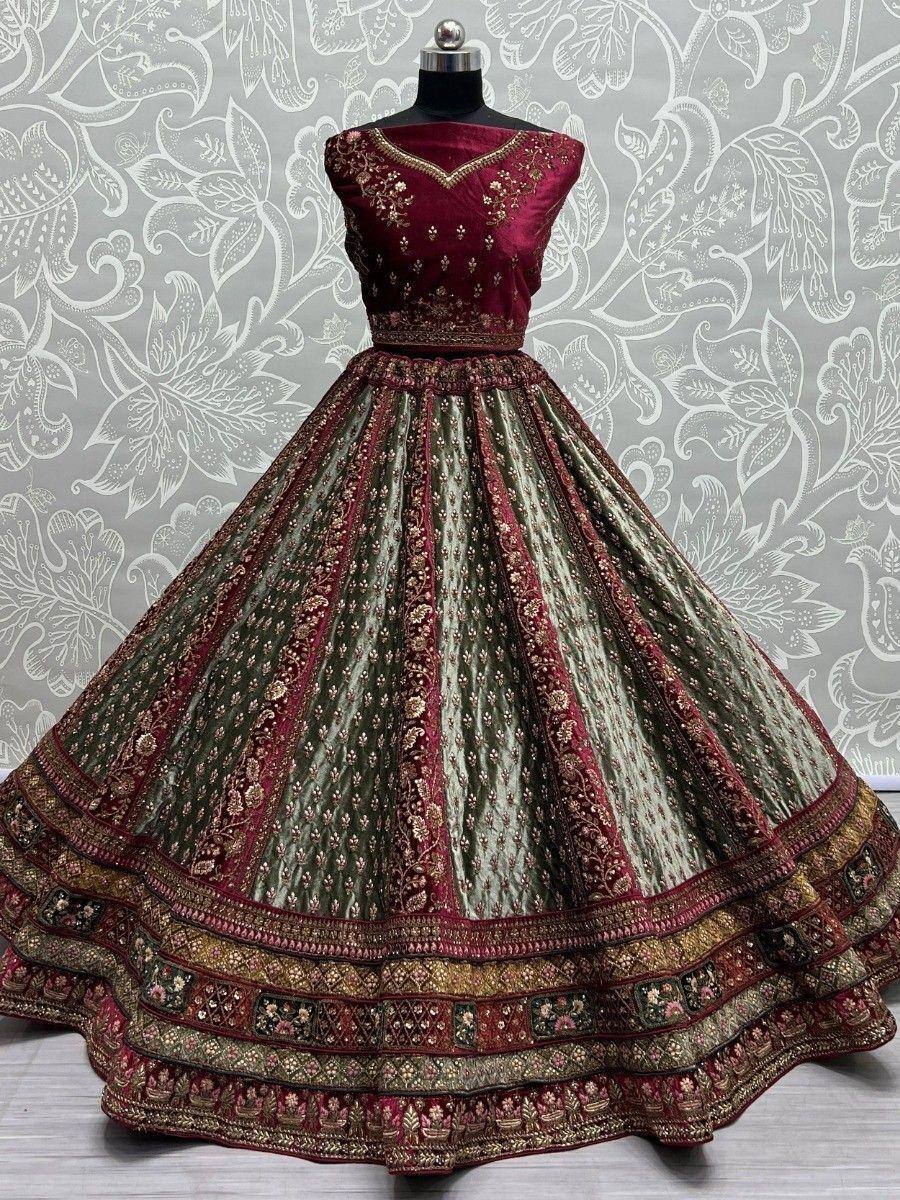 Elegant maroon and green embroidered lehenga choli with intricate gold detailing, perfect for Indian ethnic wear.