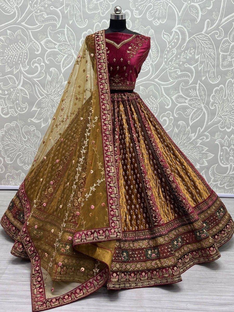 Maroon and gold designer lehenga choli with intricate embroidery and net dupatta, perfect for weddings and festivals.
