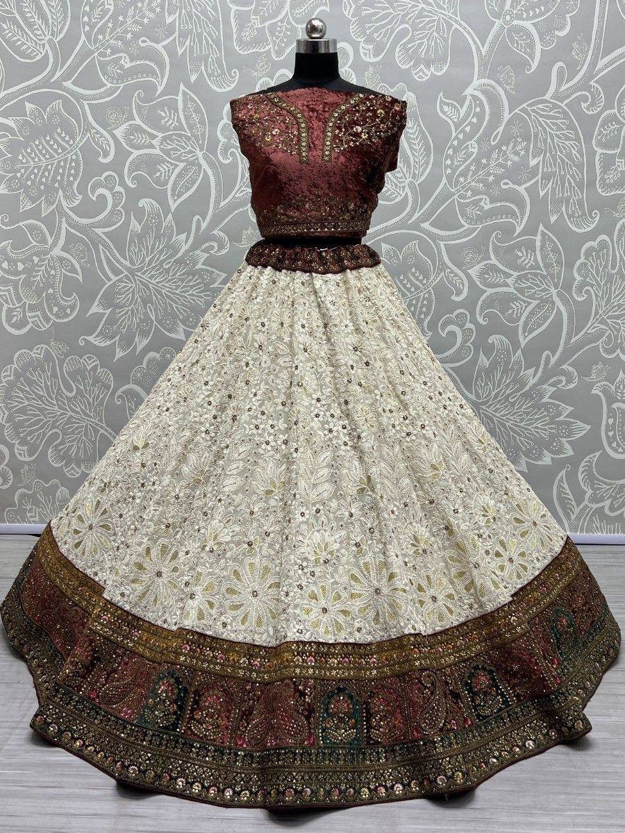 Elegant cream and maroon lehenga choli with intricate embroidery and embellished border, perfect for Indian ethnic wear.