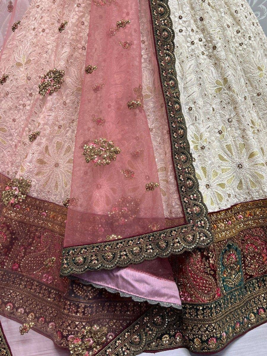 Pink and white embroidered lehenga choli with floral motifs and heavy border detailing