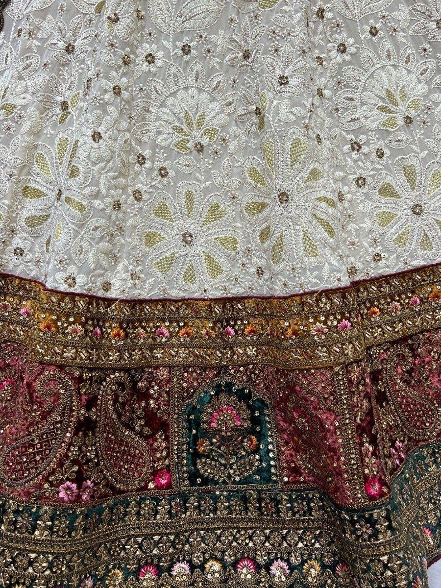 White and maroon embroidered lehenga with floral gold detailing and sequin border